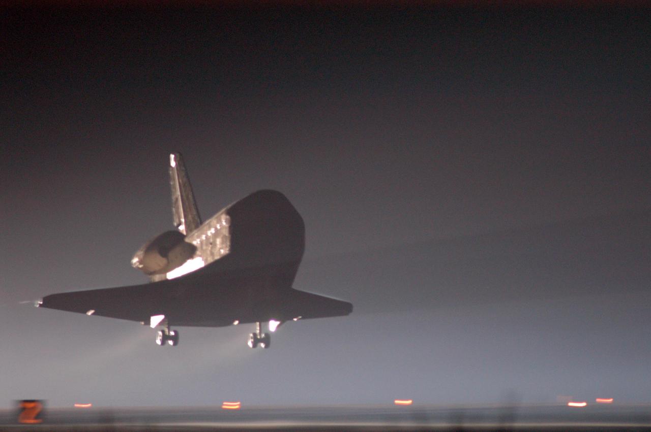 KENNEDY SPACE CENTER, FLA. -   Just before dawn, Atlantis nears touchdown on Runway 33 at NASA's Kennedy Space Center, concluding mission STS-115.  Aboard are Commander Brent Jett, Pilot Christopher Ferguson, and Mission Specialists Joseph Tanner, David Burbank, Heidemarie Stefanyshyn-Piper and Steven MacLean, who represents the Canadian Space Agency.  During the mission, Tanner, McLean, Burbank and Piper completed three spacewalks to attach the P3/P4 integrated truss structure to the International Space Station.  Main gear touchdown was at 6:21:30 a.m. EDT.  Nose gear touchdown was at 6:21:36 a.m. and wheel stop was at 6:22:16 a.m.  At touchdown -- nominally about 2,500 ft. beyond the runway threshold -- the orbiter is traveling at a speed ranging from 213 to 226 mph. Atlantis traveled 4.9 million miles, landing on orbit 187. Mission elapsed time was 11 days, 19 hours, six minutes. This is the 15th night landing at KSC and the 23rd night landing overall.  Photo credit: NASA/John Kechele