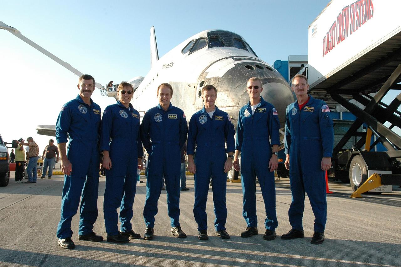 KENNEDY SPACE CENTER, FLA. - The STS-115 crew poses in front of the orbiter Atlantis, which brought them safely back from space to NASA's Kennedy Space Center.  From left are Mission Specialists Daniel Burbank, Heidemarie Stefanyshyn-Piper and Steven MacLean; Pilot Christopher Ferguson; Commander Brent Jett; and Mission Specialist Joseph Tanner.  During the mission, Tanner, McLean, Burbank and Piper completed three spacewalks to attach the P3/P4 integrated truss structure to the International Space Station.  Main gear touchdown was at 6:21:30 a.m. EDT.  Nose gear touchdown was at 6:21:36 a.m. and wheel stop was at 6:22:16 a.m.  Atlantis traveled 4.9 million miles, landing on orbit 187. Mission elapsed time was 11 days, 19 hours, six minutes. This is the 15th night landing at KSC and the 23rd night landing overall.  Photo credit: NASA/Kim Shiflett