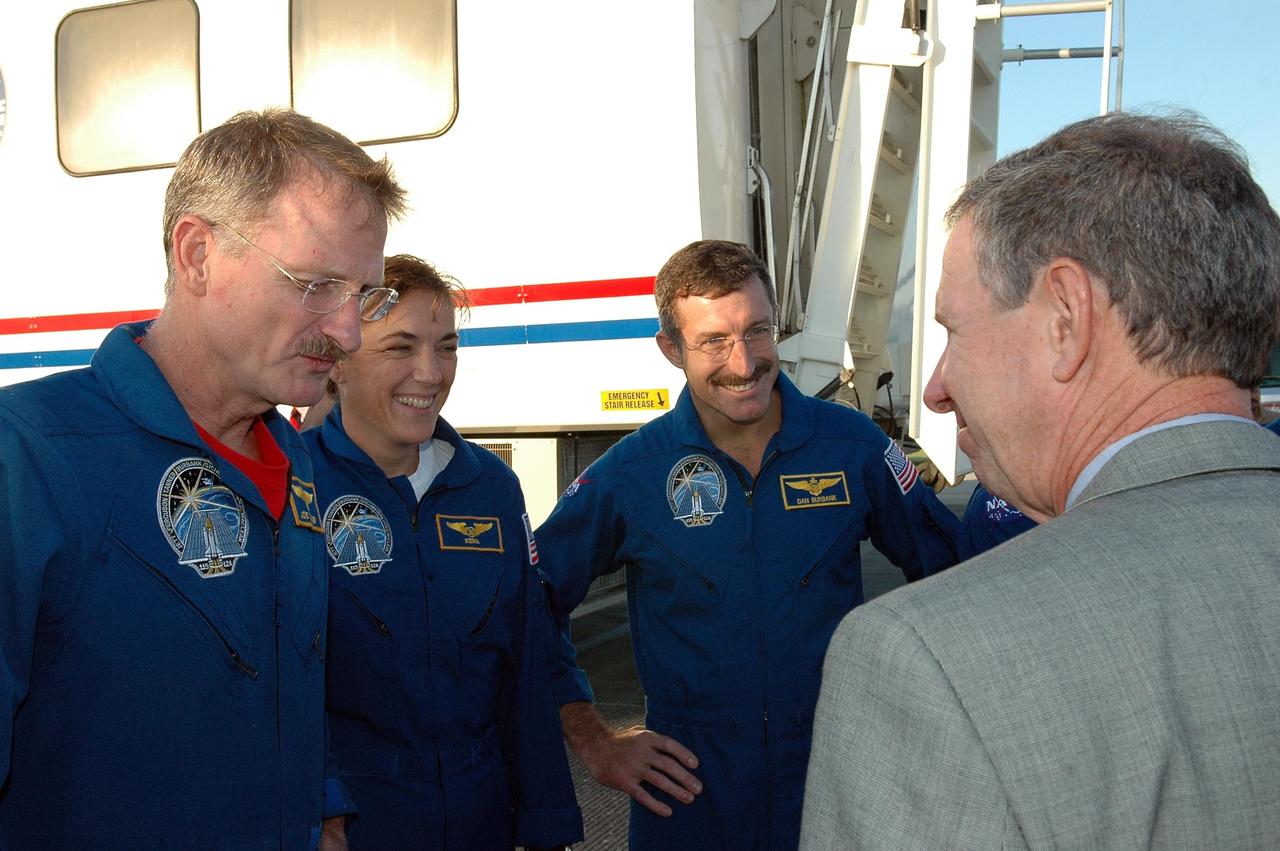 KENNEDY SPACE CENTER, FLA. - NASA Administrator Michael Griffin, right, talks to the STS-115 crew after its return from space.  The crew members shown are Mission Specialists Joseph Tanner,  Heidemarie Stefanyshyn-Piper and Daniel Burbank.  During the mission, astronauts completed three spacewalks to attach the P3/P4 integrated truss structure to the International Space Station.  Main gear touchdown was at 6:21:30 a.m. EDT.  Nose gear touchdown was at 6:21:36 a.m. and wheel stop was at 6:22:16 a.m.  Atlantis traveled 4.9 million miles, landing on orbit 187. Mission elapsed time was 11 days, 19 hours, six minutes. This is the 15th night landing at KSC and the 23rd night landing overall.  Photo credit: NASA/Kim Shiflett
