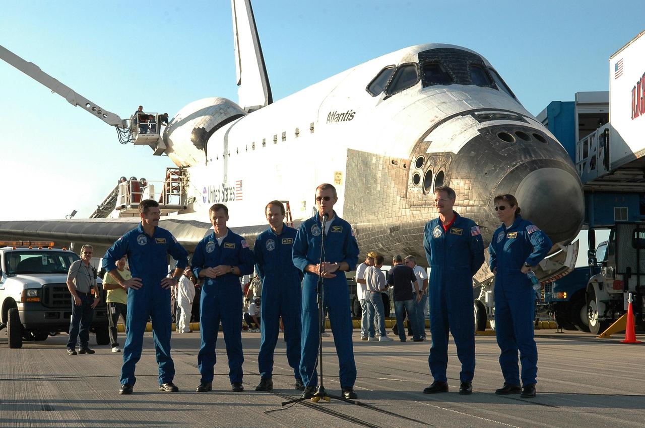KENNEDY SPACE CENTER, FLA. - After a safe landing aboard Atlantis on Runway 33 of the Shuttle Landing Facility, the STS-115 crew greets the media.  At the microphone is Commander Brent Jett.  Behind him, left to right, are Mission Specialist Daniel Burbank, Pilot Christopher Ferguson and Mission Specialists Steven MacLean, Joseph Tanner and Heidemarie Stefanyshyn-Piper.  During the mission, astronauts completed three spacewalks to attach the P3/P4 integrated truss structure to the International Space Station.  Main gear touchdown was at 6:21:30 a.m. EDT.  Nose gear touchdown was at 6:21:36 a.m. and wheel stop was at 6:22:16 a.m.  Atlantis traveled 4.9 million miles, landing on orbit 187. Mission elapsed time was 11 days, 19 hours, six minutes. This is the 15th night landing at KSC and the 23rd night landing overall.  Photo credit: NASA/Kim Shiflett