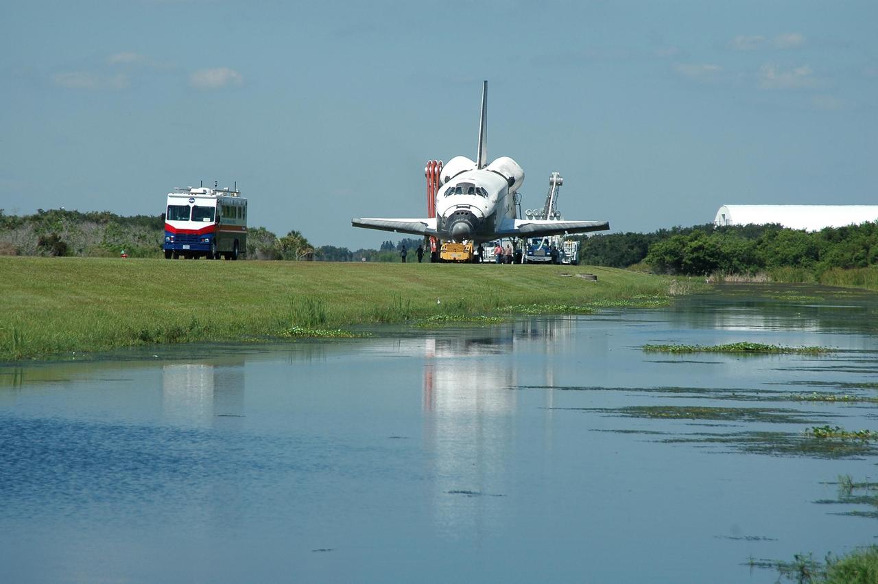 KENNEDY SPACE CENTER, FLA. -  Led by the Convoy Command Center, Atlantis is towed from the Shuttle Landing Facility to the Orbiter Processing Facility.  The command center is the prime vehicle to control critical communications between the orbiter, the crew and the Launch Control Center after a shuttle landing, to monitor the health of the shuttle orbiter systems and to direct convoy operations at the Shuttle Landing Facility.  Atlantis landed on Runway 33 at 6:21:30 a.m. EDT after the 11-day, 19-hour, 6-minute mission STS-115 to the International Space Station.  Atlantis traveled 4.9 million miles, landing on orbit 187. During the mission, astronauts delivered and installed the massive P3/P4 truss, an integral part of the station's backbone, and two sets of solar arrays that will eventually provide one quarter of the station's power. In the OPF, the process flow will begin to ready the vehicle for its next flight.  Photo credit: NASA/Kim Shiflett
