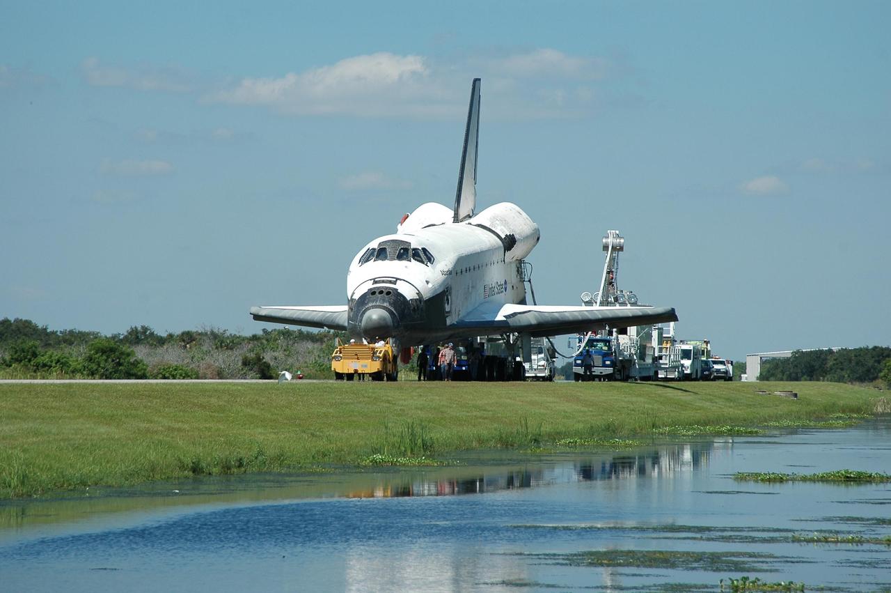 KENNEDY SPACE CENTER, FLA. -  With umbilicals still attached, the orbiter Atlantis is being towed from the Shuttle Landing Facility to the Orbiter Processing Facility.  Atlantis landed on Runway 33 at 6:21:30 a.m. EDT after the 11-day, 19-hour, 6-minute mission STS-115 to the International Space Station.  Atlantis traveled 4.9 million miles, landing on orbit 187. During the mission, astronauts delivered and installed the massive P3/P4 truss, an integral part of the station's backbone, and two sets of solar arrays that will eventually provide one quarter of the station's power. In the OPF, the process flow will begin to ready the vehicle for its next flight.  Photo credit: NASA/Kim Shiflett