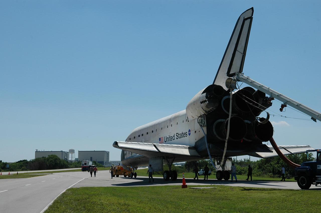 KENNEDY SPACE CENTER, FLA. -  Atlantis is towed  to the Orbiter Processing Facility along the tow-way from the Shuttle Landing Facility.  Atlantis landed on Runway 33 at 6:21:30 a.m. EDT after the 11-day, 19-hour, 6-minute mission STS-115 to the International Space Station.  Atlantis traveled 4.9 million miles, landing on orbit 187. During the mission, astronauts delivered and installed the massive P3/P4 truss, an integral part of the station's backbone, and two sets of solar arrays that will eventually provide one quarter of the station's power. In the OPF, the process flow will begin to ready the vehicle for its next flight.  Photo credit: NASA/Kim Shiflett