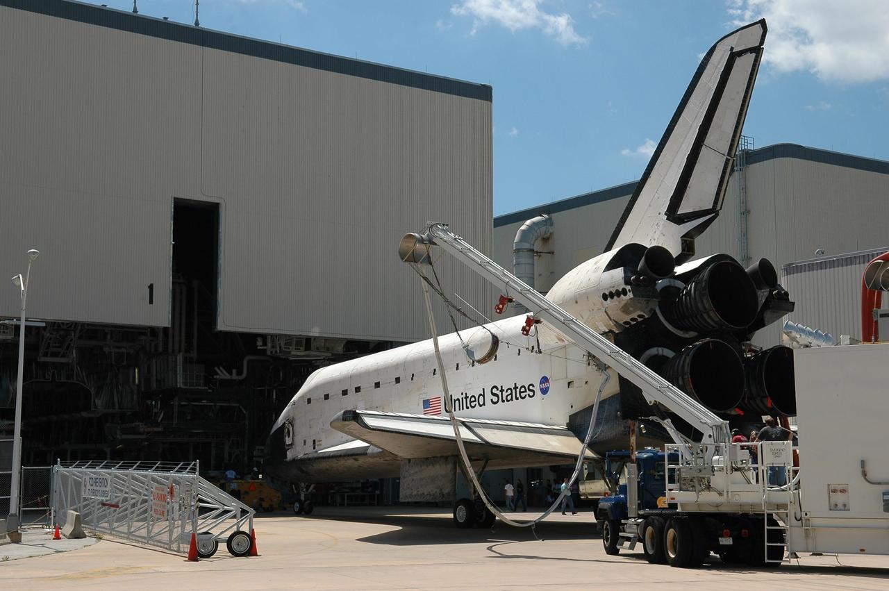 KENNEDY SPACE CENTER, FLA. -  Atlantis is moved into the Orbiter Processing Facility after being towed from the Shuttle Landing Facility.  Atlantis landed on Runway 33 at 6:21:30 a.m. EDT after the 11-day, 19-hour, 6-minute mission STS-115 to the International Space Station.  Atlantis traveled 4.9 million miles, landing on orbit 187. During the mission, astronauts delivered and installed the massive P3/P4 truss, an integral part of the station's backbone, and two sets of solar arrays that will eventually provide one quarter of the station's power. In the OPF, the process flow will begin to ready the vehicle for its next flight.  Photo credit: NASA/Kim Shiflett