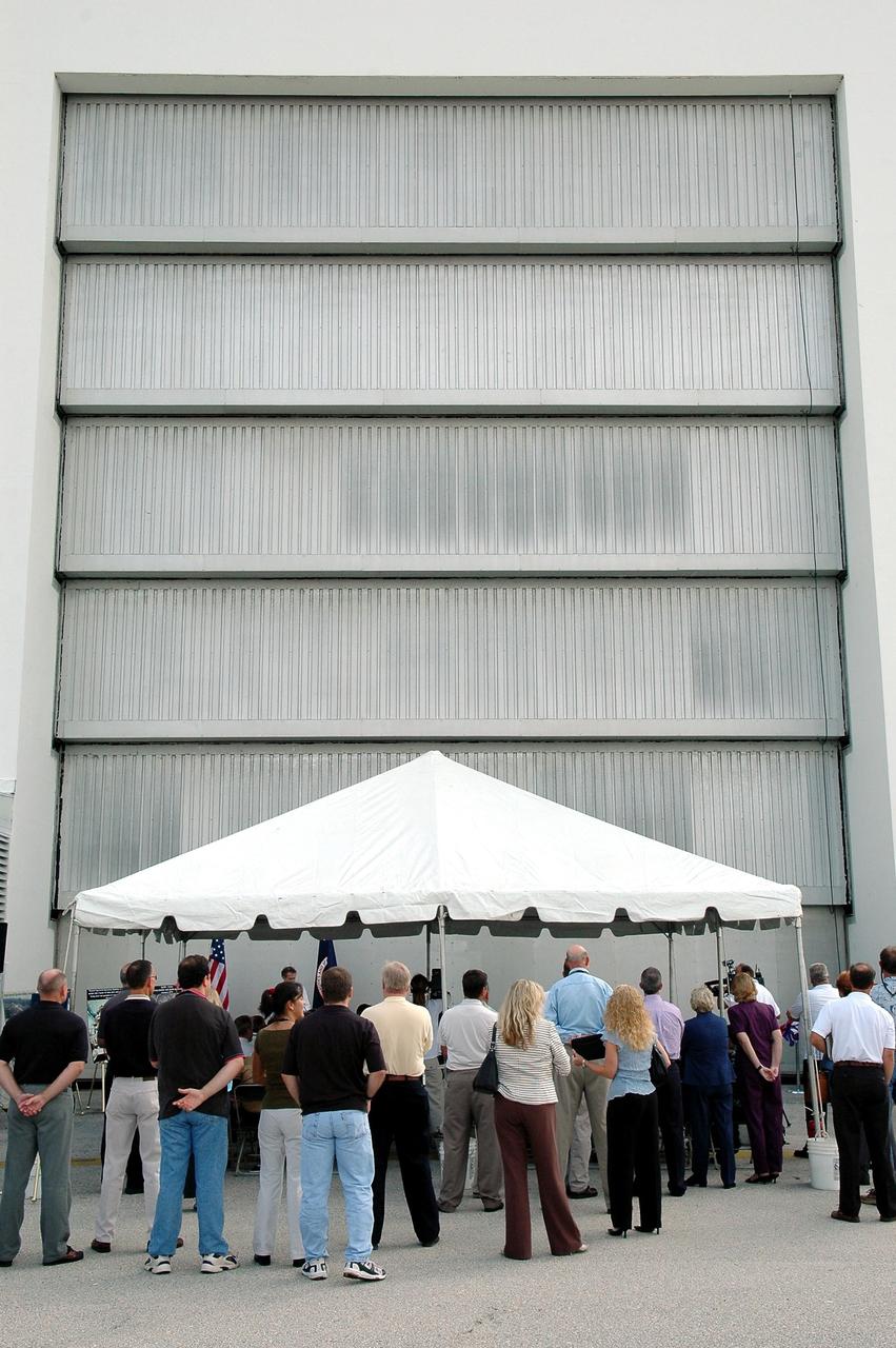 KENNEDY SPACE CENTER, FLA. - Following ribbon-cutting ceremony, workers and officials wait outside the west door to the Operations and Checkout Building for its reactivation as the entry into the crew exploration vehicle environment. During the rest of the decade, KSC will transition from launching space shuttles to launching new vehicles in NASA’s Vision For Space Exploration. Photo credit: NASA/Kim Shiflett