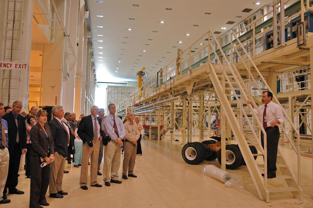 KENNEDY SPACE CENTER, FLA. -  At right, Kent Beringer, manager of facilities with Boeing, briefs Center Director Jim Kennedy (second from left at front) and other officials about use of the area dedicated for the crew exploration vehicle in the Operations and Checkout Building.  The briefing followed an official ribbon-cutting that reactivated the entry into the area.   During the rest of the decade, KSC will transition from launching space shuttles to launching new vehicles in NASA’s Vision For Space Exploration. Photo credit: NASA/Kim Shiflett