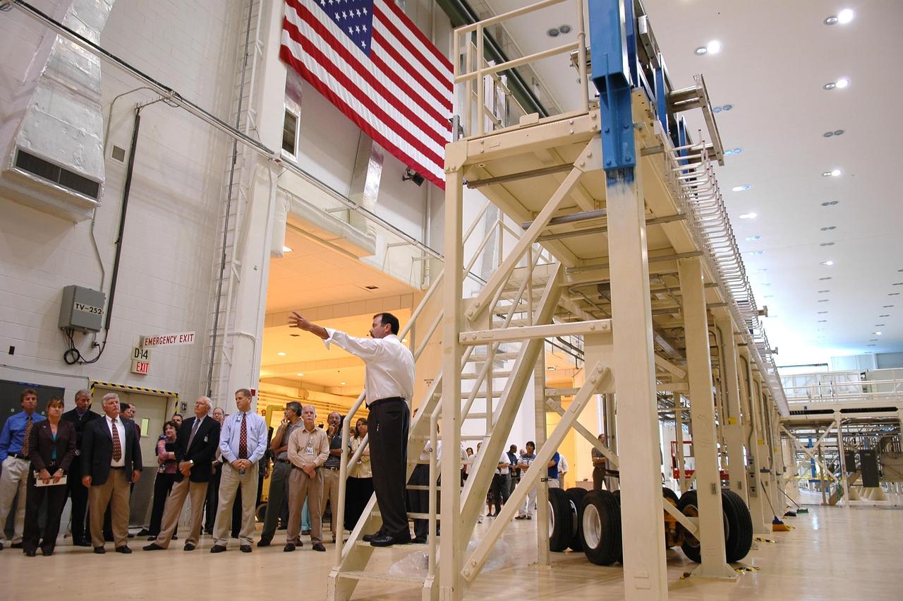 KENNEDY SPACE CENTER, FLA. -  At right, Kent Beringer, manager of facilities with Boeing, briefs Center Director Jim Kennedy (second from left at front) and other officials about use of the area dedicated for the crew exploration vehicle in the Operations and Checkout Building.  The briefing followed an official ribbon-cutting that reactivated the entry into the area.  During the rest of the decade, KSC will transition from launching space shuttles to launching new vehicles in NASA’s Vision For Space Exploration. Photo credit: NASA/Kim Shiflett