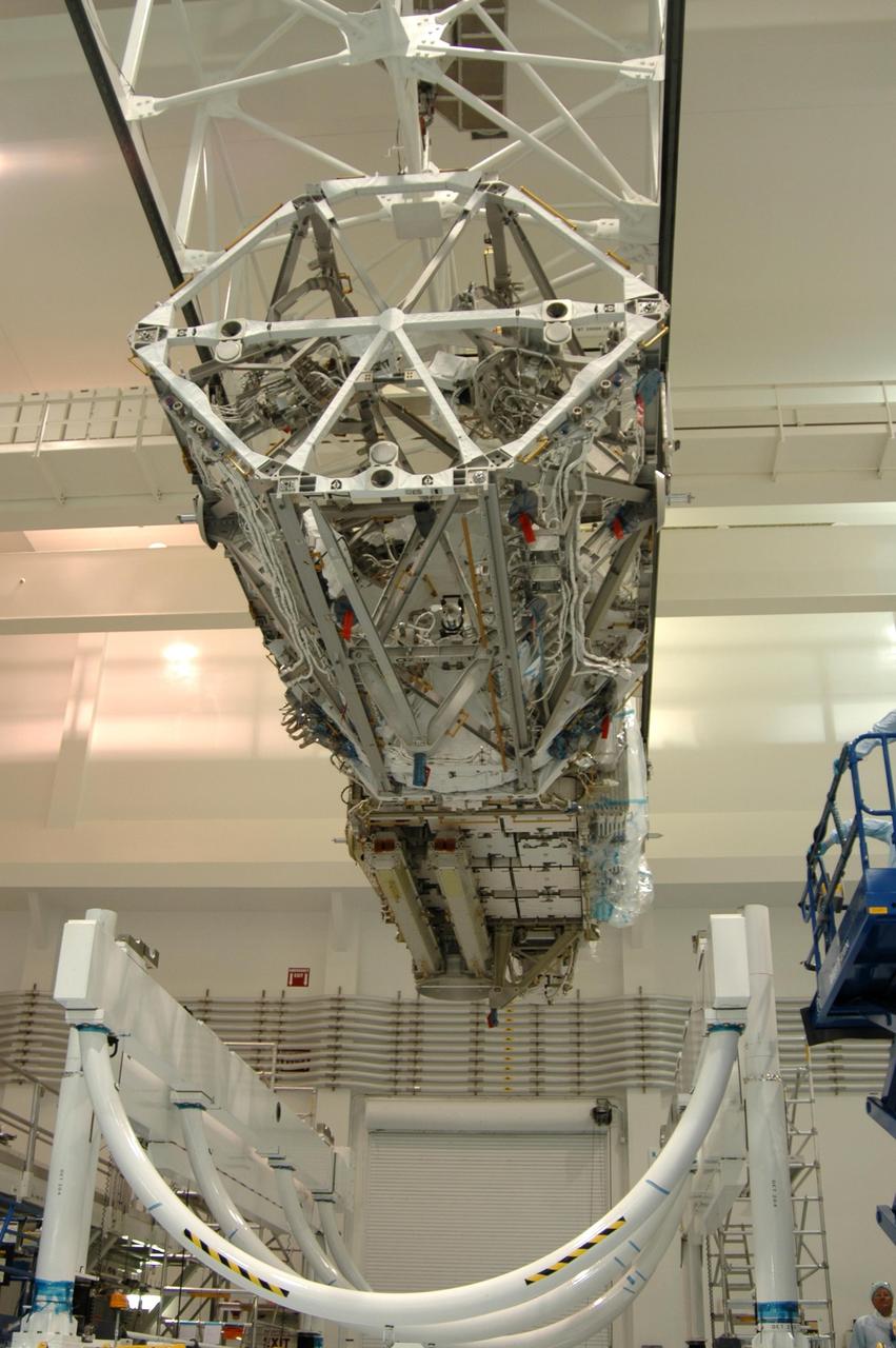 KENNEDY SPACE CENTER, FLA. - In the Space Station Processing Facility, an overhead crane lifts the S3/S4 integrated truss structure from a rotation stand. The truss will be moved to a work stand. Along with a third set of solar arrays and batteries, the truss is scheduled to fly on mission STS-117 aboard Space Shuttle Atlantis to the International Space Station. The crew of six astronauts will install the truss to continue assembly of the station. Photo credit: NASA/Dimitri Gerondidakis