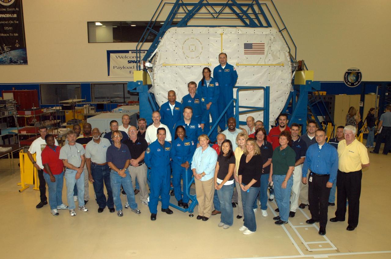 KENNEDY SPACE CENTER, FLA. - At SPACEHAB in Cape Canaveral, Fla., the STS-116 crew poses with the workers during a familiarization period. On the stairs, bottom to top, are Pilot William Oefelein, Mission Specialists Joan Higginbotham, Nicholas Patrick, Robert Curbeam, Christer Fuglesang and Sunita Williams, and Commander Mark Polansky. The Swedish Fuglesang represents the European Space Agency. Mission crews make frequent trips to the Space Coast to become familiar with the equipment and payloads they will be using. STS-116 will be mission number 20 to the International Space Station and construction flight 12A.1. The mission payload is the SPACEHAB module, the P5 integrated truss structure and other key components. Launch is scheduled for no earlier than Dec. 7. Photo credit: NASA/George Shelton