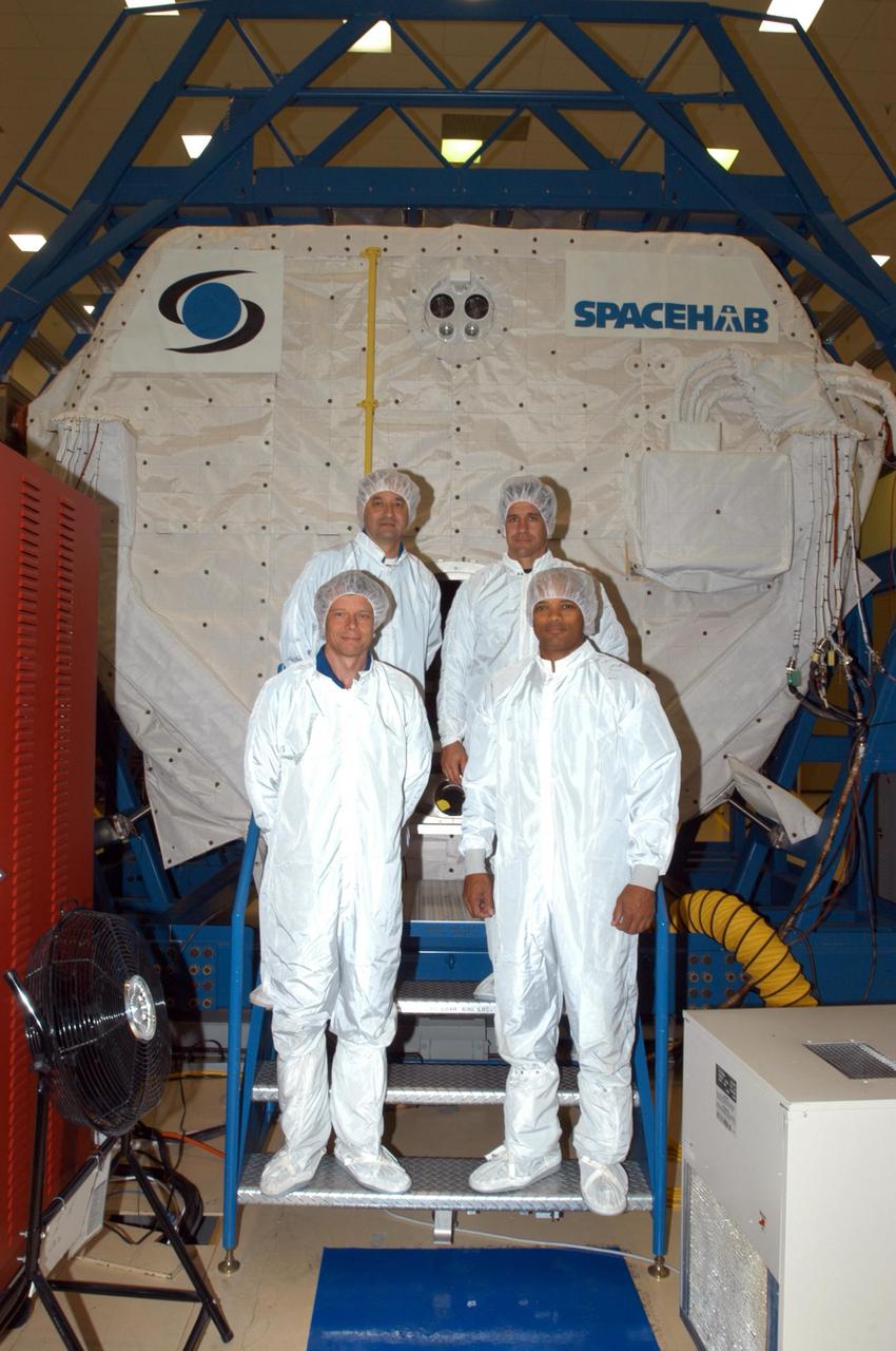 KENNEDY SPACE CENTER, FLA. -  At SPACEHAB in Cape Canaveral, Fla., STS-116 crew members are dressed in "bunny suits" before going inside the SPACEHAB module.  In front are Mission Specialists Christer Fuglesang and Robert Curbeam; in back are Commander Mark Polansky and Pilot William Oefelein.  Fuglesang, from Sweden,  represents the European Space Agency.  Mission crews make frequent trips to the Space Coast to become familiar with the equipment and payloads they will be using.  STS-116 will be mission number 20 to the International Space Station and construction flight 12A.1.  The mission payload is the SPACEHAB module, the P5 integrated truss structure and other key components.   Launch is scheduled for no earlier than Dec. 7.  Photo credit: NASA/George Shelton