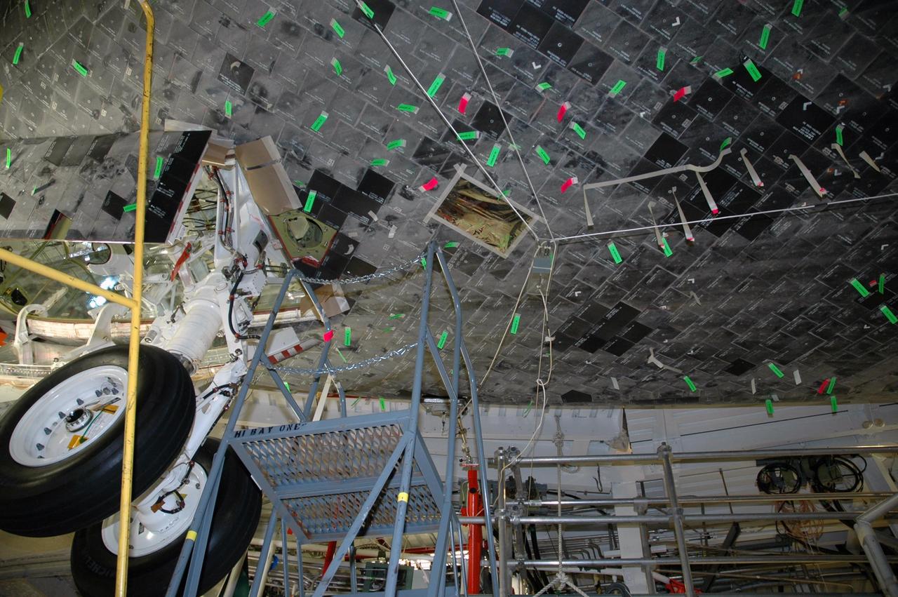 KENNEDY SPACE CENTER, FLA. - In bay 3 of the Orbiter Processing Facility, the thermal protection system tiles on the underside of Atlantis are marked for post-flight inspection. Atlantis returned from mission STS-115 on Sept. 21 and is being prepared for her next mission, STS-117. The mission will be the 21st to the International Space Station and construction flight 13A. The mission payload comprises the starboard arrays 3 and 4. Launch is scheduled for no earlier than Feb. 22, 2007. Photo credit: NASA/Jack Pfaller