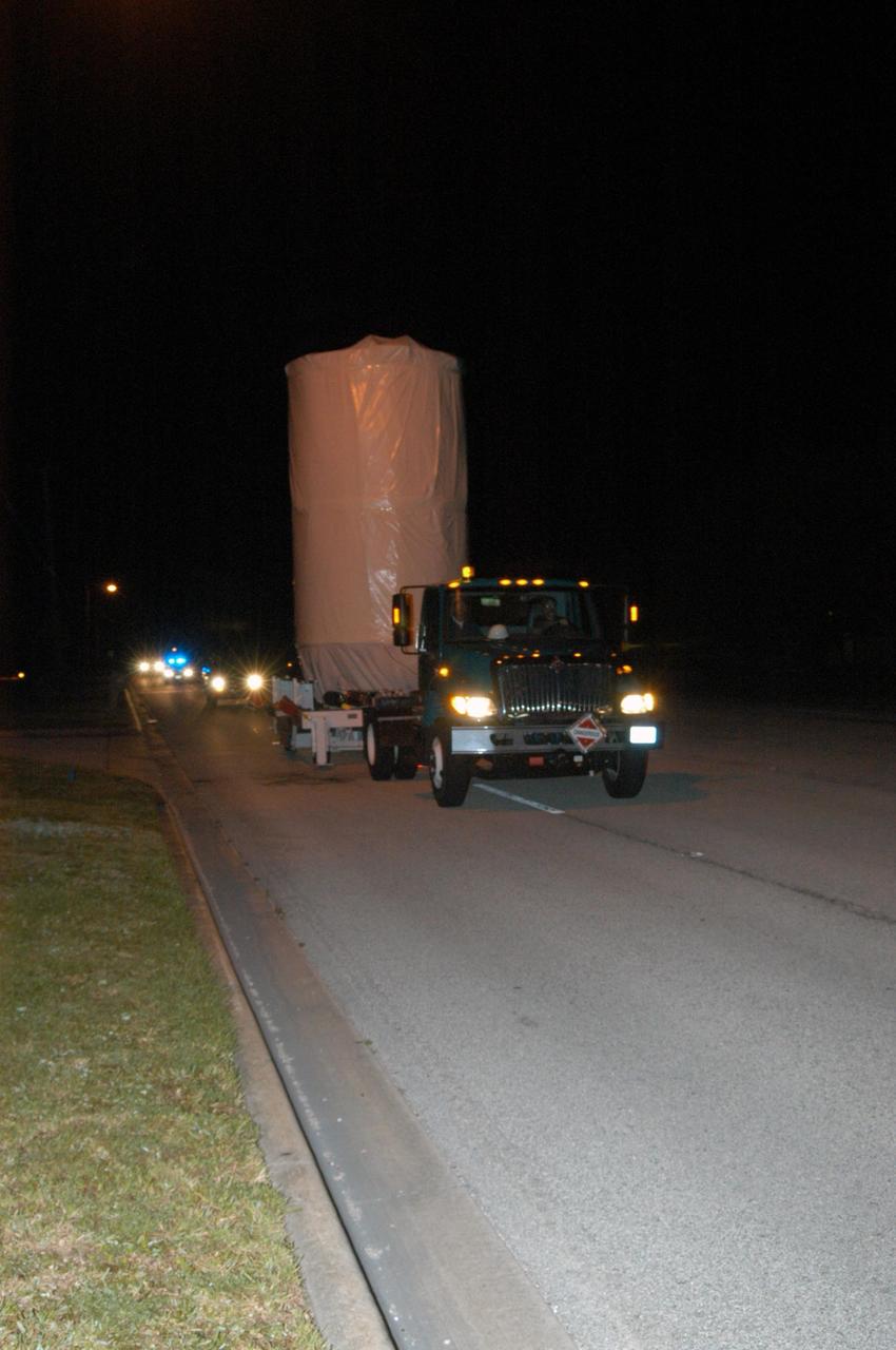KENNEDY SPACE CENTER, FLA. - With a convoy of escorts, the STEREO spacecraft is transported to Launch Pad 17-B on Cape Canaveral Air Force Station. At the pad the spacecraft will be lifted into the mobile service tower. STEREO stands for Solar Terrestrial Relations Observatory and comprises two spacecraft. The STEREO mission is the first to take measurements of the sun and solar wind in 3-dimension. This new view will improve our understanding of space weather and its impact on the Earth. The STEREO mission is managed by Goddard Space Flight Center. The Applied Physics Laboratory designed and built the spacecraft. The laboratory will maintain command and control of the observatories throughout the mission, while NASA tracks and receives the data, determines the orbit of the satellites, and coordinates the science results. STEREO is expected to lift off Oct. 25. Photo credit: NASA/George Shelton