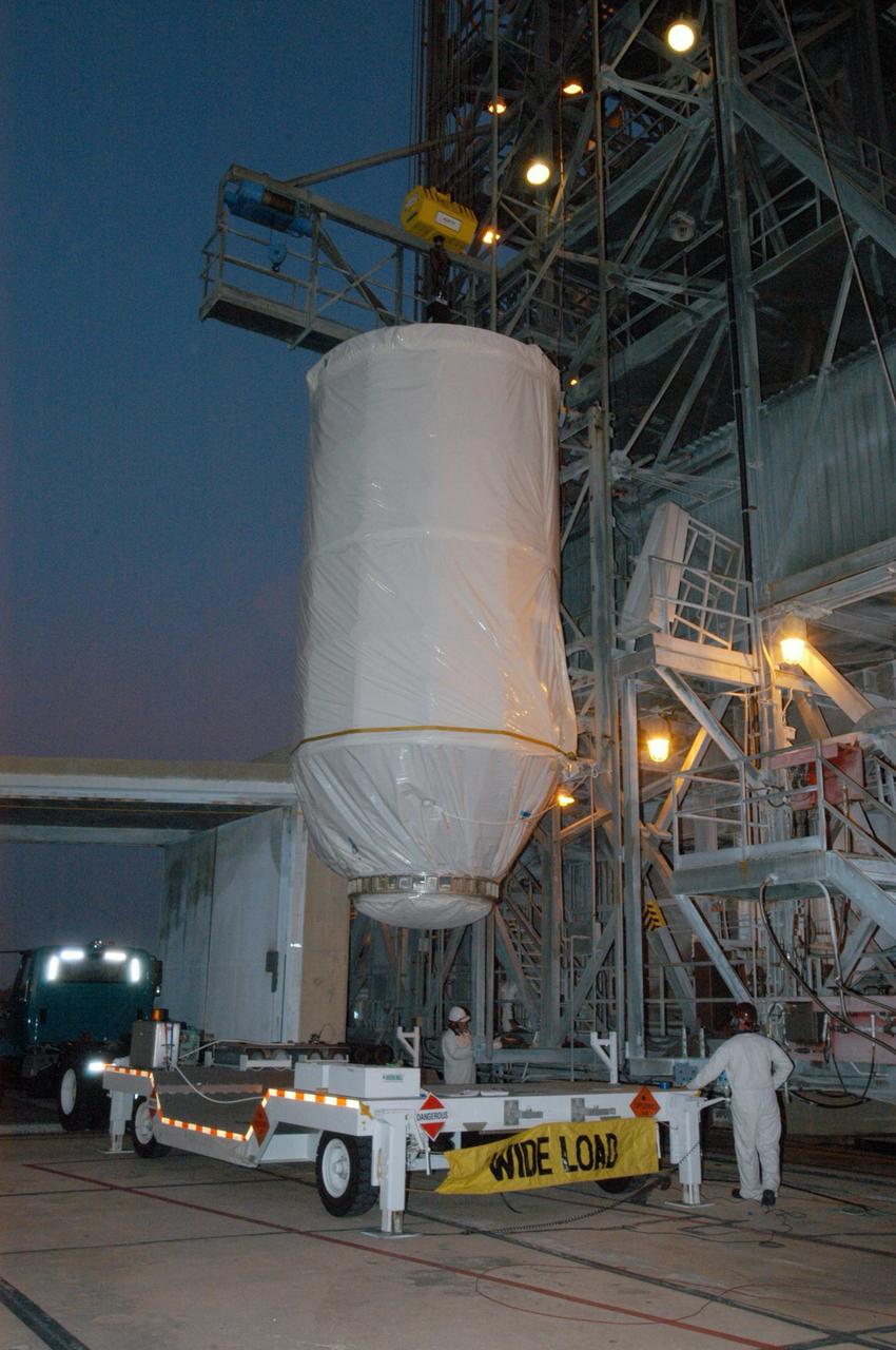 KENNEDY SPACE CENTER, FLA. - On Launch Pad 17-B at Cape Canaveral Air Force Station, the STEREO spacecraft is lifted off its transporter alongside the mobile service tower. In the tower, STEREO will be mated with its launch vehicle, a Boeing Delta II rocket. STEREO stands for Solar Terrestrial Relations Observatory and comprises two spacecraft. The STEREO mission is the first to take measurements of the sun and solar wind in 3-dimension. This new view will improve our understanding of space weather and its impact on the Earth. The STEREO mission is managed by Goddard Space Flight Center. The Applied Physics Laboratory designed and built the spacecraft. The laboratory will maintain command and control of the observatories throughout the mission, while NASA tracks and receives the data, determines the orbit of the satellites, and coordinates the science results. STEREO is expected to lift off Oct. 25. Photo credit: NASA/George Shelton