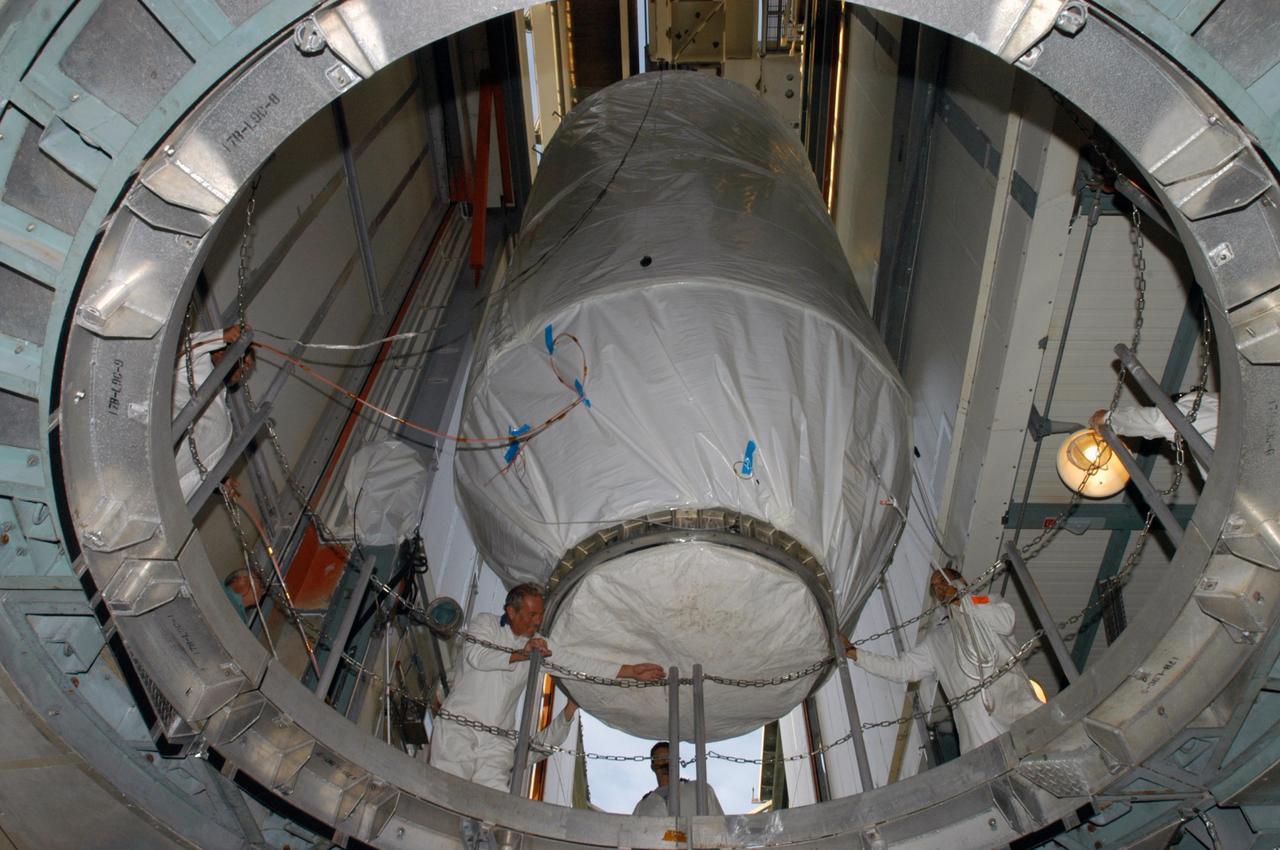 KENNEDY SPACE CENTER, FLA. - Inside the mobile service tower on Launch Pad 17-B at Cape Canaveral Air Force Station, workers check the clearance of the STEREO spacecraft as it is moved away from the opening. In the tower, STEREO will be mated with its launch vehicle, a Boeing Delta II rocket. STEREO stands for Solar Terrestrial Relations Observatory and comprises two spacecraft. The STEREO mission is the first to take measurements of the sun and solar wind in 3-dimension. This new view will improve our understanding of space weather and its impact on the Earth. The STEREO mission is managed by Goddard Space Flight Center. The Applied Physics Laboratory designed and built the spacecraft. The laboratory will maintain command and control of the observatories throughout the mission, while NASA tracks and receives the data, determines the orbit of the satellites, and coordinates the science results. STEREO is expected to lift off Oct. 25. Photo credit: NASA/George Shelton