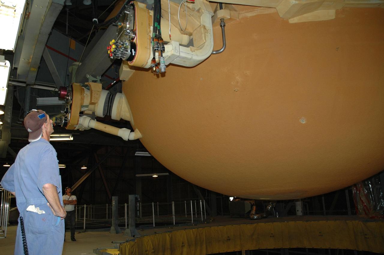 KENNEDY SPACE CENTER, FLA. - Inside the Vehicle Assembly Building, workers prepare to transfer the external tank from the checkout cell for attaching to its twin solid rocket boosters on the mobile launch platform in highbay 3 for mission STS-116. The gigantic, rust-colored external tank is the largest element of the Space Shuttle system at 27.6-feet wide and 154-feet tall. STS-116 will be mission no. 20 to the International Space Station and construction flight 12A.1. The mission payload is the SPACEHAB module, the P5 integrated truss structure and other key components. Launch is scheduled for no earlier than Dec. 7. Photo credit: NASA/Jack Pfaller