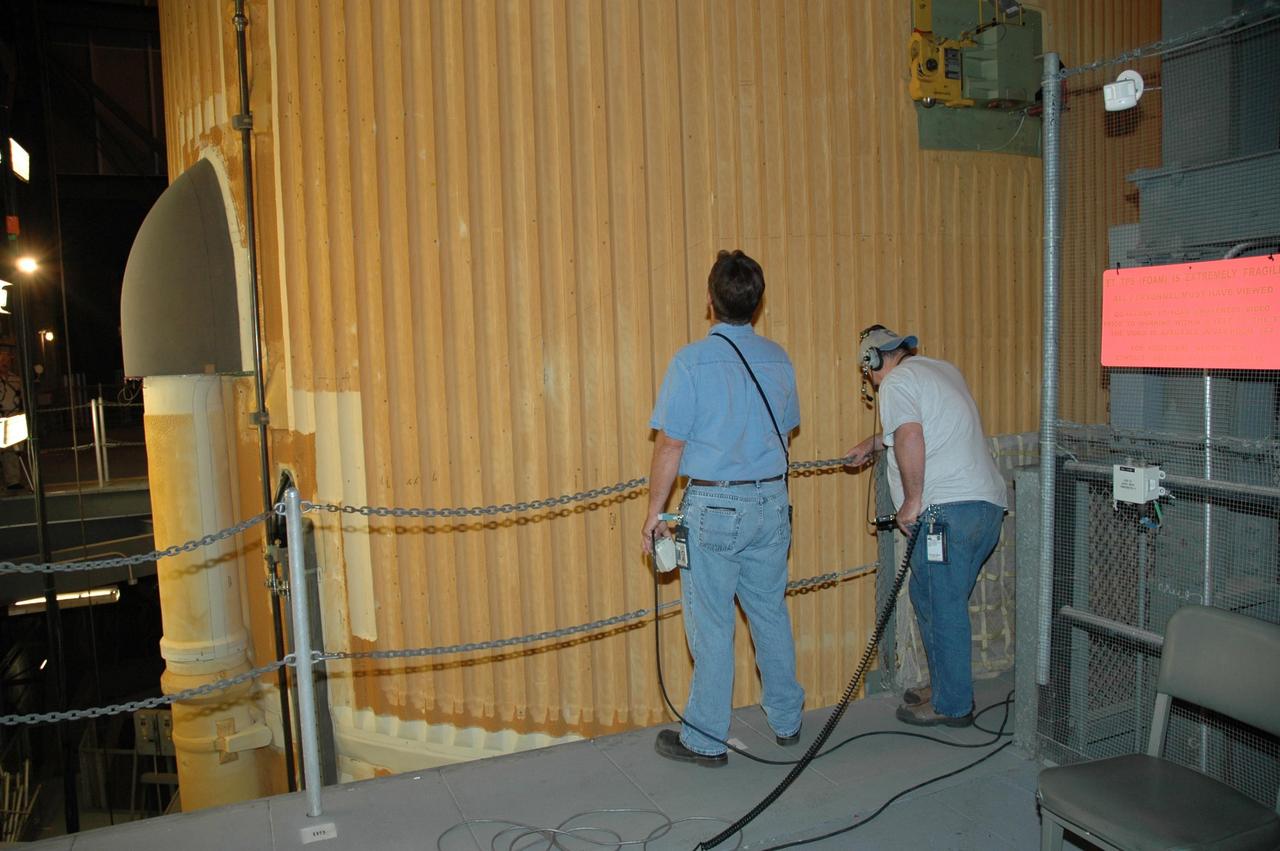 KENNEDY SPACE CENTER, FLA. - Inside the Vehicle Assembly Building, workers prepare to transfer the external tank from the checkout cell for attaching to its twin solid rocket boosters on the mobile launch platform in highbay 3 for mission STS-116. The gigantic, rust-colored external tank is the largest element of the Space Shuttle system at 27.6-feet wide and 154-feet tall. STS-116 will be mission no. 20 to the International Space Station and construction flight 12A.1. The mission payload is the SPACEHAB module, the P5 integrated truss structure and other key components. Launch is scheduled for no earlier than Dec. 7. Photo credit: NASA/Jack Pfaller
