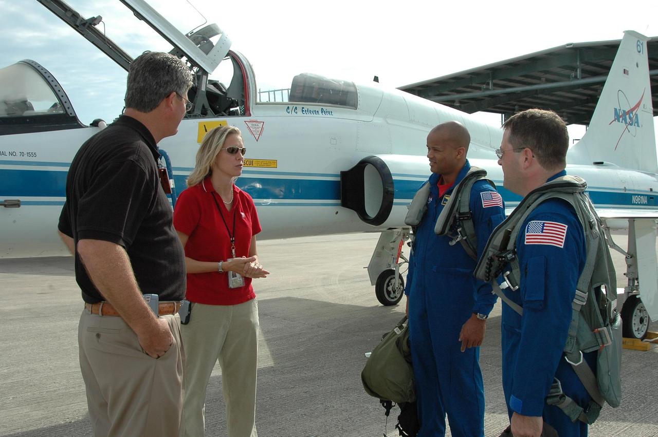KENNEDY SPACE CENTER, FLA. -  From left, at Kennedy Space Center’s Shuttle Landing Facility, Deputy Director William Parsons and Discovery Flow Director Stephanie Stilson greet STS-116 Mission Specialists Robert Curbeam and Nicholas Patrick after they arrive for the Crew Equipment Interface Test.  Mission crews make frequent trips to the Space Coast to become familiar with the equipment and payloads they will be using. STS-116 will be mission No. 20 to the International Space Station and construction flight 12A.1. The mission payload is the SPACEHAB module, the P5 integrated truss structure and other key components.  Launch is scheduled for no earlier than Dec. 7.  Photo credit: NASA/Kim Shiflett