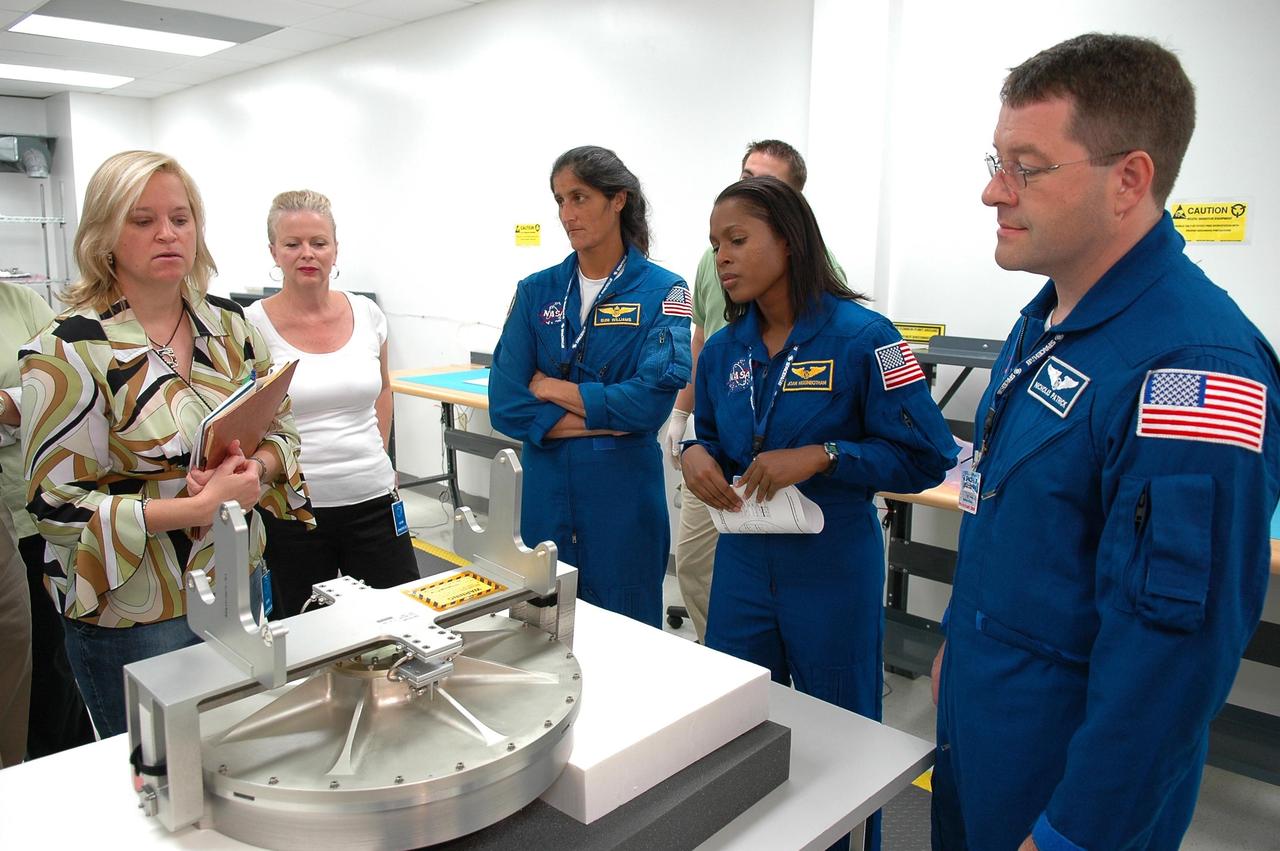 KENNEDY SPACE CENTER, FLA. -   Inside the SPACEHAB Payload Processing Facility at Port Canaveral, Fla., STS-116 Mission Specialists (from left) Sunita Williams, Joan Higginbotham and Nicholas Patrick look over flight hardware during the Crew Equipment Interface Test. Mission crews make frequent trips to the Space Coast to become familiar with the equipment and payloads they will be using. STS-116 will be mission No. 20 to the International Space Station and construction flight 12A.1. The mission payload is the SPACEHAB module, the P5 integrated truss structure and other key components.  Launch is scheduled for no earlier than Dec. 7.  Photo credit: NASA/Kim Shiflett