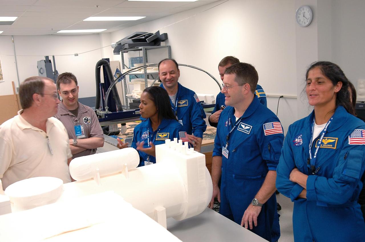 KENNEDY SPACE CENTER, FLA. - Mission STS-116 crew members participate in the Crew Equipment Interface Test at the SPACEHAB Payload Processing Facility at Port Canaveral, Fla. From left are Mission Specialists Joan Higgenbotham, Nicholas Patrick and Sunita Willams. Behind them are Commander Mark Polansky and Mission Specialist Christer Fuglesang, who is with the European Space Agency. Mission crews make frequent trips to the Space Coast to become familiar with the equipment and payloads they will be using. STS-116 will be mission No. 20 to the International Space Station and construction flight 12A.1. The mission payload is the SPACEHAB module, the P5 integrated truss structure and other key components. Launch is scheduled for no earlier than Dec. 7. Photo credit: NASA/Kim Shiflett