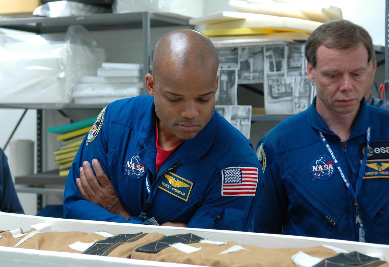KENNEDY SPACE CENTER, FLA. - STS-116 Mission Specialists Robert Curbeam and Christer Fuglesang, who is with the European Space Agency, inspect flight hardware at the SPACEHAB Payload Processing Facility at Port Canaveral, Fla., during the Crew Equipment Interface Test. Mission crews make frequent trips to the Space Coast to become familiar with the equipment and payloads they will be using. STS-116 will be mission No. 20 to the International Space Station and construction flight 12A.1. The mission payload is the SPACEHAB module, the P5 integrated truss structure and other key components. Launch is scheduled for no earlier than Dec. 7. Photo credit: NASA/Kim Shiflett