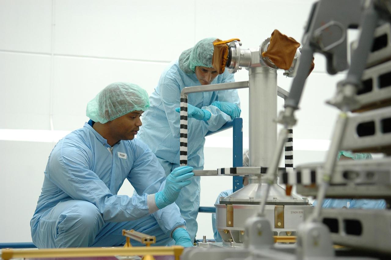 KENNEDY SPACE CENTER, FLA. - Inside Astrotech Space Operations in Titusville, Fla., STS-116 Mission Specialists Robert Curbeam and Sunita Williams inspect flight hardware during the Crew Equipment Interface Test. Mission crews make frequent trips to the Space Coast to become familiar with the equipment and payloads they will be using. STS-116 will be mission No. 20 to the International Space Station and construction flight 12A.1. The mission payload is the SPACEHAB module, the P5 integrated truss structure and other key components. Launch is scheduled for no earlier than Dec. 7. Photo credit: NASA/Kim Shiflett