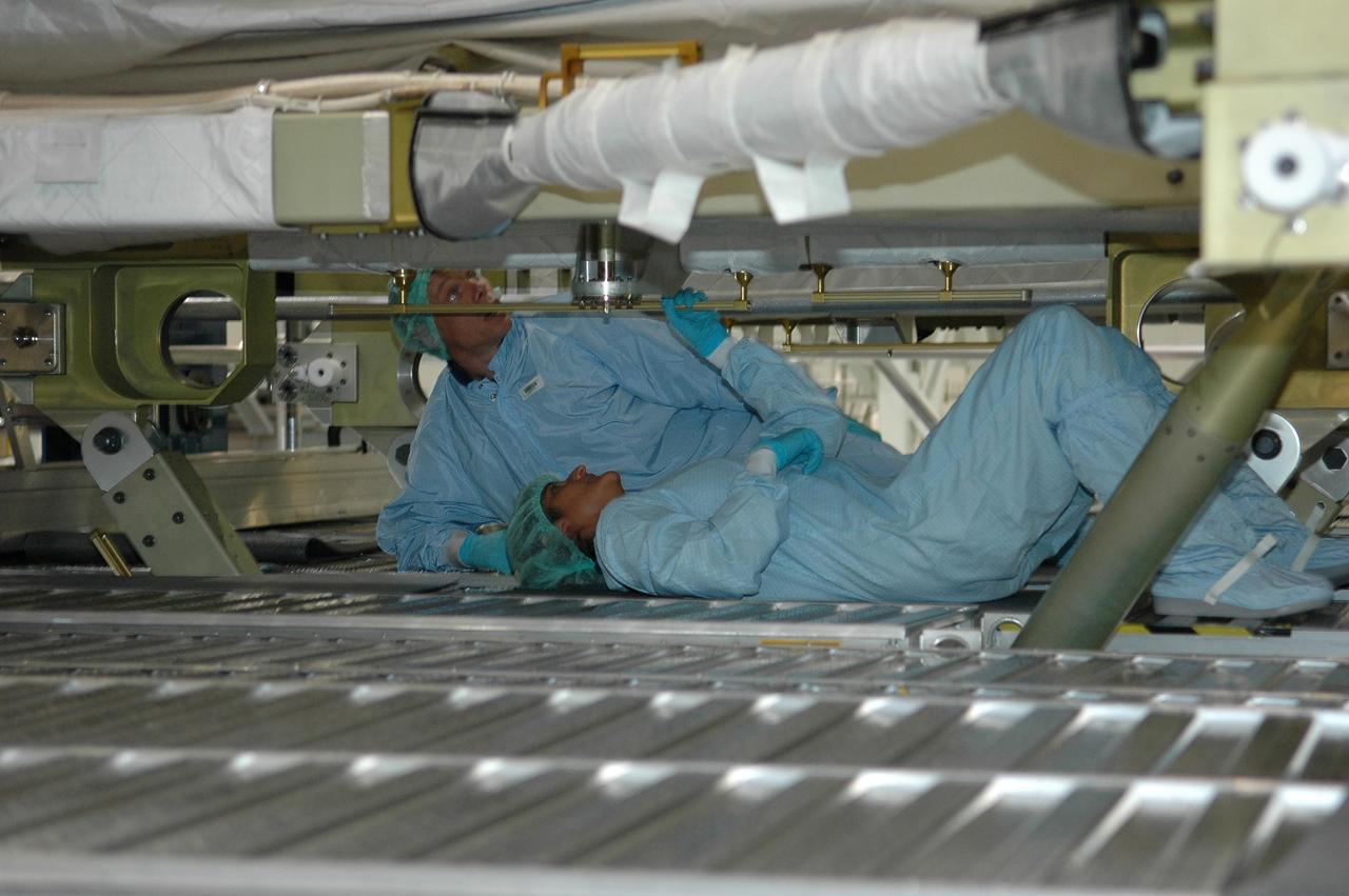 KENNEDY SPACE CENTER, FLA. - In the Space Station Processing Facility, STS-116 crew members check out the port integrated truss structure, P5, which is the primary payload on their mission. Seen here are Mission Specialists Christer Fugelsang, who represents the European Space Agency, and Sunita Williams. The crew is taking part in a Crew Equipment Interface Test that enables them to become familiar with the equipment and payloads they will be using. STS-116 will be mission No. 20 to the International Space Station and construction flight 12A.1. The mission payload is the SPACEHAB module, the P5 integrated truss structure and other key components. Launch is scheduled for no earlier than Dec. 7. Photo credit: NASA/Kim Shiflett