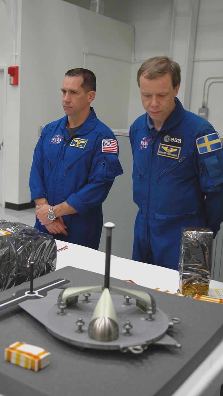 KENNEDY SPACE CENTER, FLA. -   In the Orbiter Processing Facility, members of the STS-116 crew look over flight hardware during the Crew Equipment Interface Test.  Seen here are Pilot William Oefelein (left) and Mission Specialist Christer Fugelsang, who represents the European Space Agency. Mission crews make frequent trips to the Kennedy Space Center to become familiar with the equipment and payloads they will be using.  STS-116 will be mission No. 20 to the International Space Station and construction flight 12A.1.  The mission payload is the SPACEHAB module, the P5 integrated truss structure and other key components.   Launch is scheduled for no earlier than Dec. 7.  Photo credit: NASA/Kim Shiflett