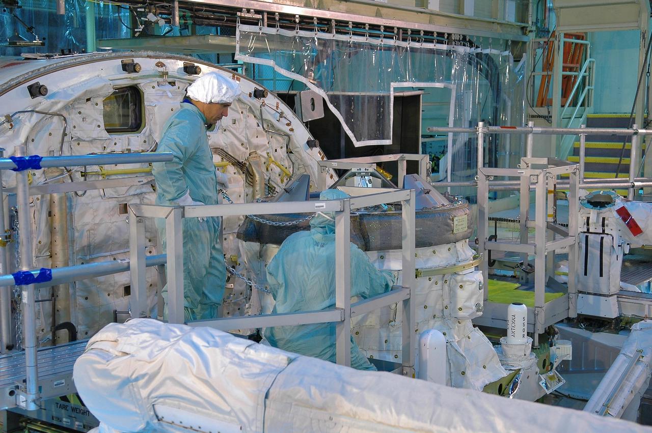 KENNEDY SPACE CENTER, FLA. -   During a Crew Equipment Interface Test (CEIT) in the Orbiter Processing Facility, STS-116 Pilot William Oefelein looks at the external air lock in Discovery’s payload bay.  A CEIT allows astronauts to become familiar with equipment and hardware they will use on the mission.  STS-116 will be mission No. 20 to the International Space Station and construction flight 12A.1.  The mission payload is the SPACEHAB module, the P5 integrated truss structure and other key components.   Launch is scheduled for no earlier than Dec. 7. Photo credit: NASA/Kim Shiflett