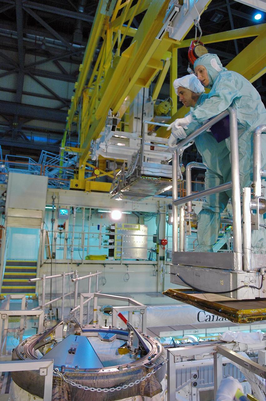 KENNEDY SPACE CENTER, FLA. -   During a Crew Equipment Interface Test (CEIT) in the Orbiter Processing Facility, STS-116 crew members are looking closely at equipment in Discovery’s payload bay. In the white cap is Pilot William Oefelein.  Below him is the top of the external air lock.  A CEIT allows astronauts to become familiar with equipment and hardware they will use on the mission.  STS-116 will be mission No. 20 to the International Space Station and construction flight 12A.1.  The mission payload is the SPACEHAB module, the P5 integrated truss structure and other key components.   Launch is scheduled for no earlier than Dec. 7. Photo credit: NASA/Kim Shiflett