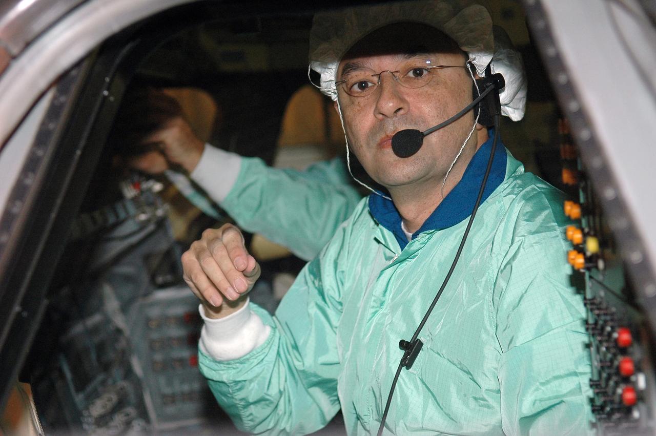 KENNEDY SPACE CENTER, FLA. -   In the Orbiter Processing Facility, STS-116 Commander Mark Polansky checks the cockpit window as part of a Crew Equipment Interface Test (CEIT).  A CEIT allows astronauts to become familiar with equipment and hardware they will use on the mission.  STS-116 will be mission No. 20 to the International Space Station and construction flight 12A.1.  The mission payload is the SPACEHAB module, the P5 integrated truss structure and other key components.   Launch is scheduled for no earlier than Dec. 7. Photo credit: NASA/Kim Shiflett