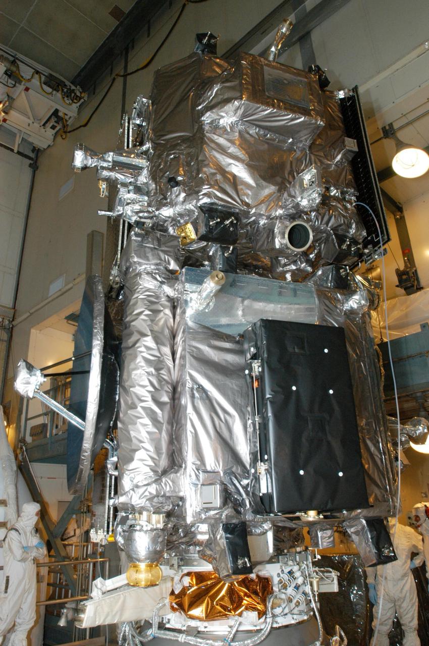 KENNEDY SPACE CENTER, FLA. -    Inside the mobile service tower on Launch Pad 17-B at Cape Canaveral Air Force Station, workers prepare the twin observatories known as STEREO for encapsulation in the fairing.  The fairing is a molded structure that fits flush with the outside surface of the Delta II upper stage booster and forms an aerodynamically smooth nose cone, protecting the spacecraft during launch and ascent. The STEREO (Solar Terrestrial Relations Observatory) mission is the first to take measurements of the sun and solar wind in 3-dimension. This new view will improve our understanding of space weather and its impact on the Earth.  Designed and built by the Applied Physics Laboratory (APL) , the STEREO mission is being managed by NASA Goddard Space Flight Center. APL will maintain command and control of the observatories throughout the mission, while NASA tracks and receives the data, determines the orbit of the satellites, and coordinates the science results. STEREO is expected to lift off Oct. 25. Photo credit: NASA/George Shelton