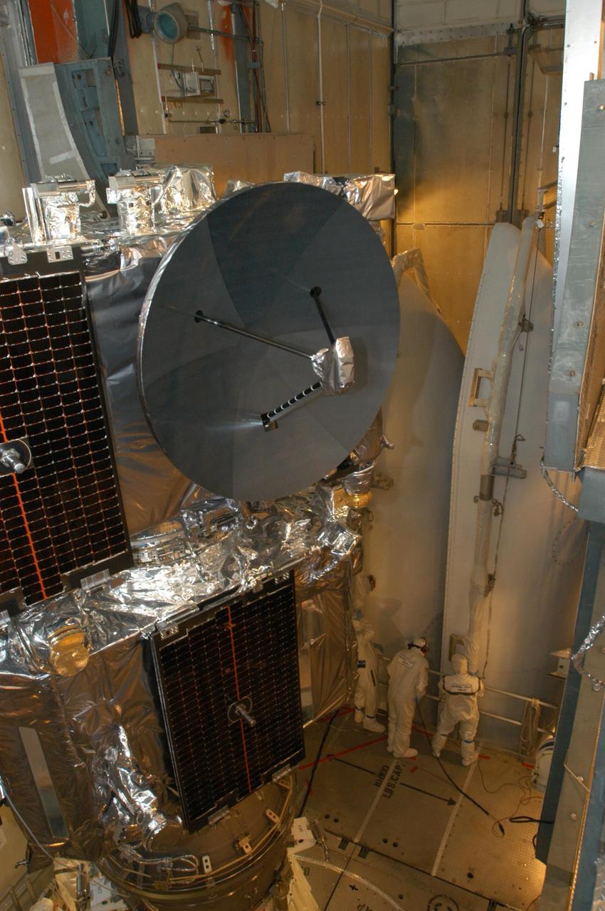 KENNEDY SPACE CENTER, FLA. -  Inside the mobile service tower on Launch Pad 17-B at Cape Canaveral Air Force Station, workers (background) observe the lifting of the two fairing segments that will encapsulate the STEREO spacecraft (foreground). The fairing is a molded structure that fits flush with the outside surface of the Delta II upper stage booster and forms an aerodynamically smooth nose cone, protecting the spacecraft during launch and ascent. The STEREO (Solar Terrestrial Relations Observatory) mission is the first to take measurements of the sun and solar wind in 3-dimension. This new view will improve our understanding of space weather and its impact on the Earth.  Designed and built by the Applied Physics Laboratory (APL) , the STEREO mission is being managed by NASA Goddard Space Flight Center. APL will maintain command and control of the observatories throughout the mission, while NASA tracks and receives the data, determines the orbit of the satellites, and coordinates the science results. STEREO is expected to lift off Oct. 25. Photo credit: NASA/George Shelton