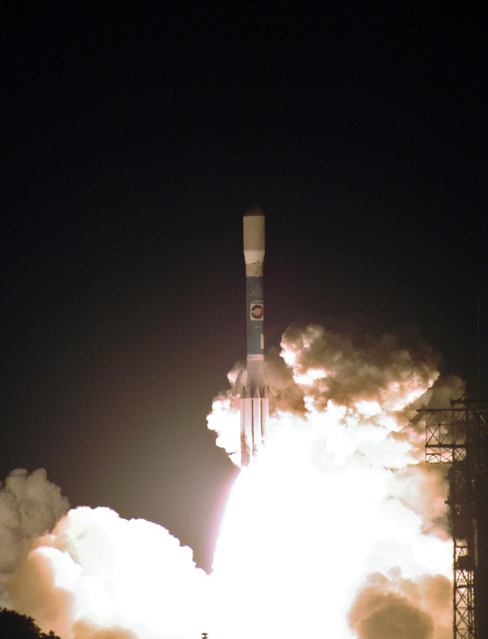 KENNEDY SPACE CENTER, FLA. - The Delta II launch vehicle carrying the STEREO spacecraft hurtles through the smoke and steam after liftoff from Launch Pad 17-B at Cape Canaveral Air Force Station. Liftoff was at 8:52 p.m. EDT. STEREO (Solar Terrestrial Relations Observatory) is a two-year mission using two nearly identical observatories, one ahead of Earth in its orbit and the other trailing behind. The duo will provide 3-D measurements of the sun and its flow of energy, enabling scientists to study the nature of coronal mass ejections and why they happen. The ejections are a major source of the magnetic disruptions on Earth and are a key component of space weather. The disruptions can greatly effect satellite operations, communications, power systems, humans in space and global climate. Designed and built by the Johns Hopkins University Applied Physics Laboratory (APL) , the STEREO mission is being managed by NASA Goddard Space Flight Center. APL will maintain command and control of the observatories throughout the mission, while NASA tracks and receives the data, determines the orbit of the satellites, and coordinates the science results.