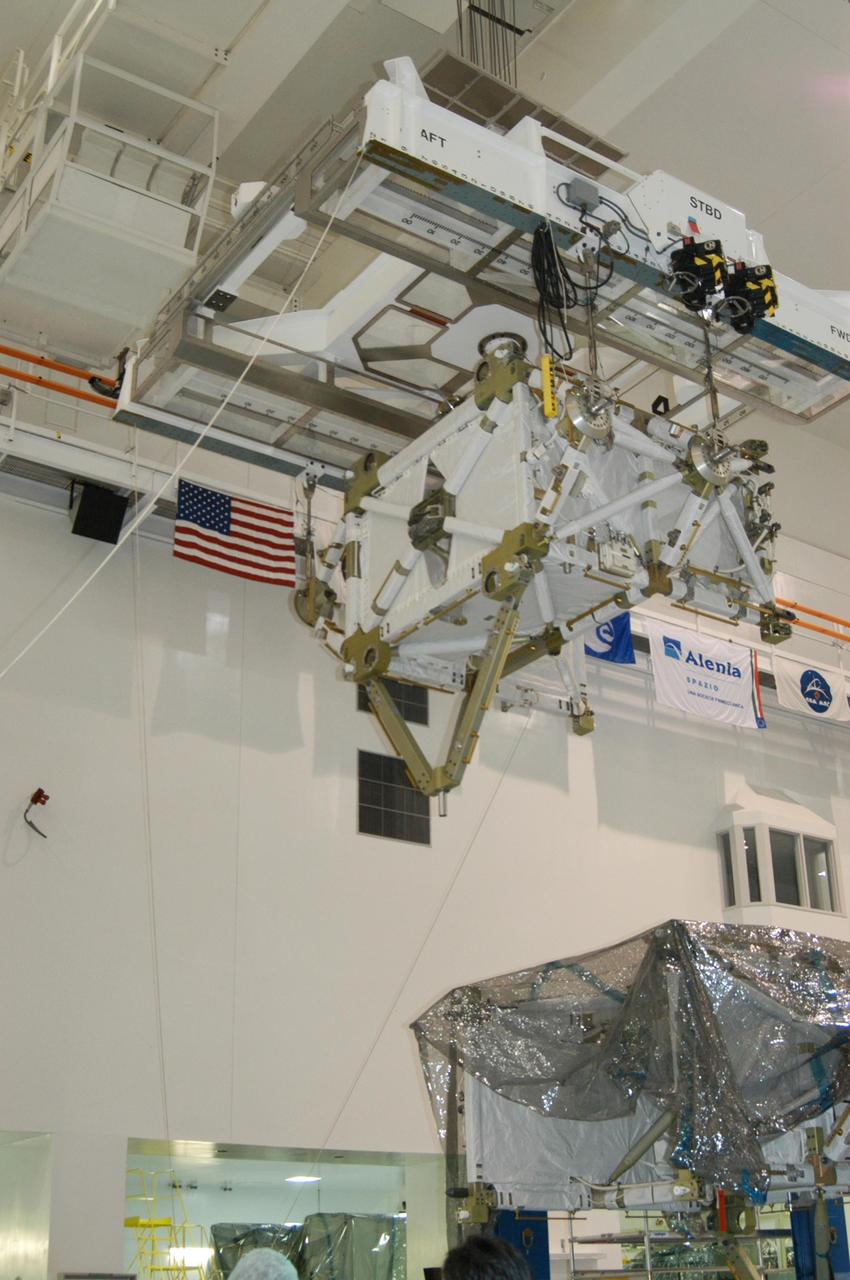 KENNEDY SPACE CENTER, FLA. -- In the Space Station Processing Facility, an overhead crane moves the P5 truss for mission STS-116 to the payload canister.   The truss will be transported to Launch Pad 39B where it will wait for installation in Space Shuttle Discovery’s payload bay. The third port truss segment, the P5 will be attached to the P3/P4 truss on the International Space Station during the 11-day mission. The window for launch of mission STS-116 opens Dec. 7.   Photo credit: NASA/George Shelton