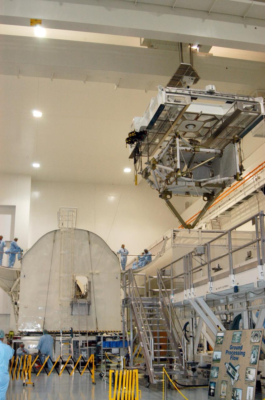 KENNEDY SPACE CENTER, FLA. -- In the Space Station Processing Facility, the P5 truss for mission STS-116 moves closer to the payload canister (left).  The canister will transport the truss to Launch Pad 39B where it will wait for installation in Space Shuttle Discovery’s payload bay.  The third port truss segment, the P5 will be attached to the P3/P4 truss on the International Space Station during the 11-day mission. The window for launch of mission STS-116 opens Dec. 7.   Photo credit: NASA/George Shelton