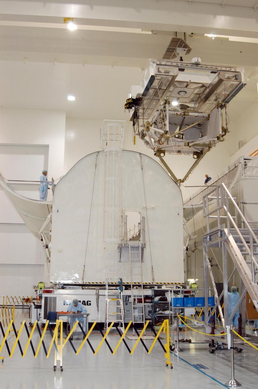 KENNEDY SPACE CENTER, FLA. --  In the Space Station Processing Facility, the P5 truss for mission STS-116 moves closer to the payload canister (left).  The canister will transport the truss to Launch Pad 39B where it will wait for installation in Space Shuttle Discovery’s payload bay.  The third port truss segment, the P5 will be attached to the P3/P4 truss on the International Space Station during the 11-day mission. The window for launch of mission STS-116 opens Dec. 7.   Photo credit: NASA/George Shelton