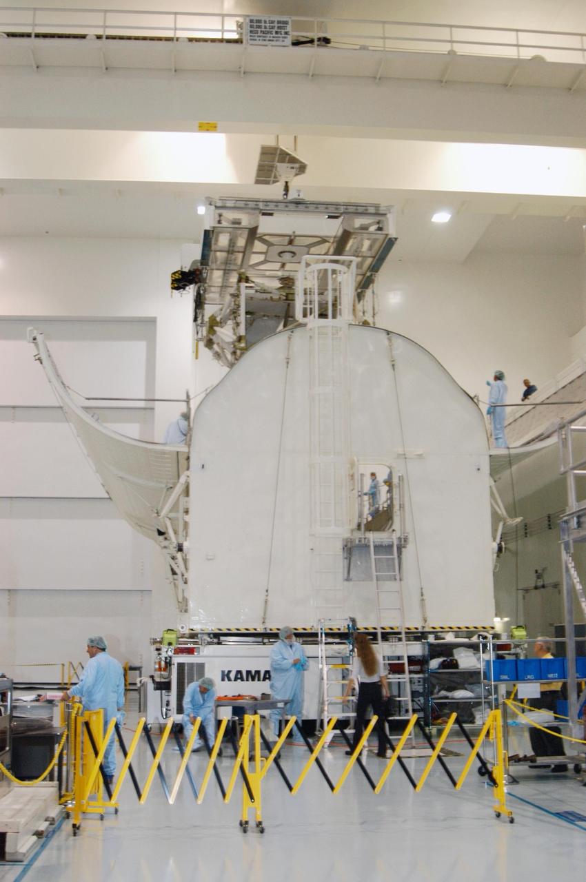 KENNEDY SPACE CENTER, FLA. --  In the Space Station Processing Facility, the P5 truss for mission STS-116 is lowered into the payload canister.  The canister will transport the truss to Launch Pad 39B where it will wait for installation in Space Shuttle Discovery’s payload bay. The third port truss segment, the P5 will be attached to the P3/P4 truss on the International Space Station during the 11-day mission. The window for launch of mission STS-116 opens Dec. 7.   Photo credit: NASA/George Shelton