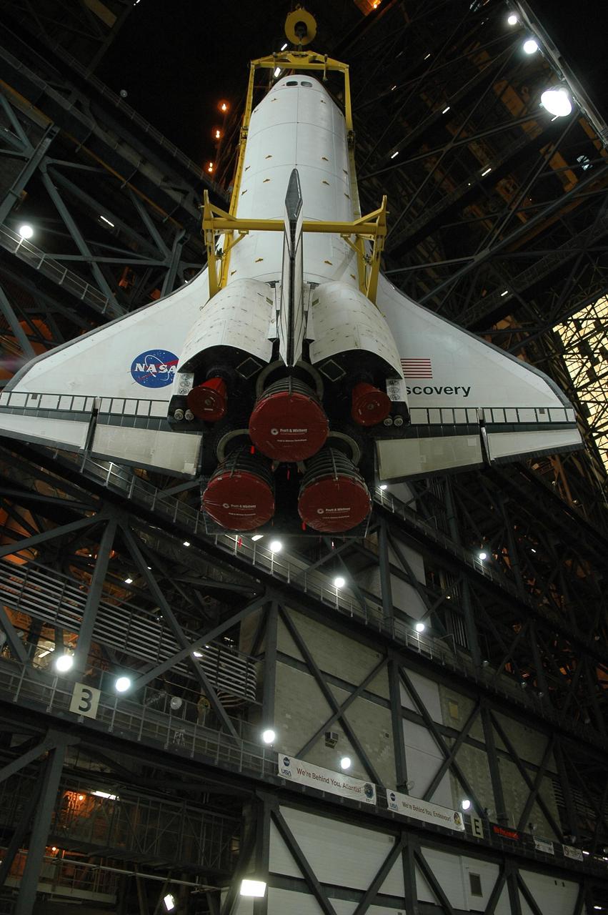 KENNEDY SPACE CENTER, FLA. -- Inside the Vehicle Assembly Building, a crane and sling attached to the orbiter Discovery lift the vehicle toward the upper levels for transfer to high bay 3. There it will be lowered onto the mobile launcher platform where the external tank and solid rocket boosters are already stacked. Space Shuttle Discovery is scheduled to roll out to Launch Pad 39B no earlier than Nov. 7 for mission STS-116. The mission is No. 20 to the International Space Station and construction flight 12A.1. The mission payload is the SPACEHAB module, the P5 integrated truss structure and other key components. The launch window for mission STS-116 opens Dec. 7. Photo credit: NASA/Kim Shiflett