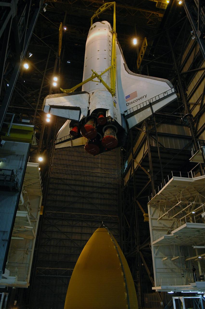 KENNEDY SPACE CENTER, FLA. -- The orbiter Discovery is being lowered into high bay 3 of the Vehicle Assembly Building toward the external tank below.  The orbiter will be stacked with the tank and solid rocket boosters already installed on the mobile launcher platform.   Space Shuttle Discovery is scheduled to roll out to Launch Pad 39B no earlier than Nov. 7 for mission STS-116.  The mission is No. 20 to the International Space Station and construction flight 12A.1. The mission payload is the SPACEHAB module, the P5 integrated truss structure and other key components. The launch window for mission STS-116 opens Dec. 7. Photo credit: NASA/Kim Shiflett