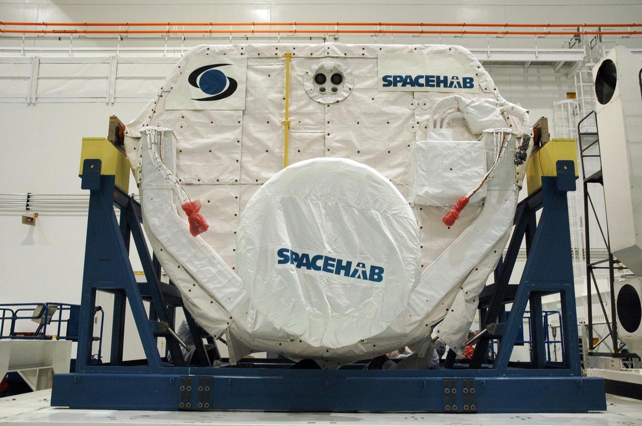 KENNEDY SPACE CENTER, FLA. --  Inside the Space Station Processing Facility, technicians secure the protective coverings on the SPACEHAB Module before it is transferred to the Payload Canister. The SPACEHAB Module will carry racks of experiments, flight hardware, spacewalk equipment and supplies to support mission STS-116 to the International Space Station. STS-116 will be mission number 20 to the station and construction flight 12A.1.  Along with SPACEHAB, the mission payload on Space Shuttle Discovery includes the P5 integrated truss structure and other key components. The launch window opens Dec. 7.  Photo credit: NASA/Troy Cryder