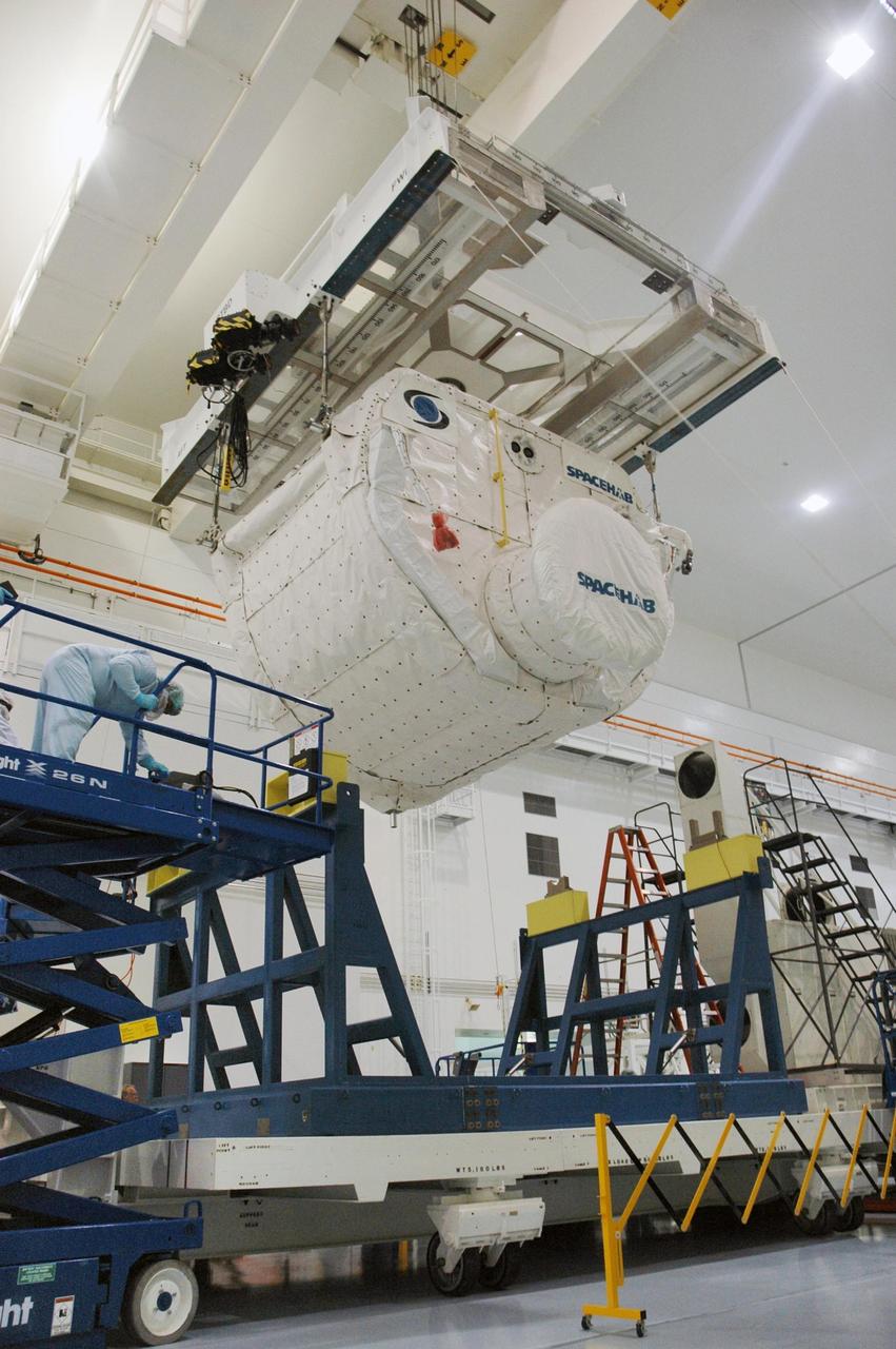 KENNEDY SPACE CENTER, FLA. --  Inside the Space Station Processing Facility, an overhead crane lifts the SPACEHAB Module from its stand for transfer to the Payload Canister. The SPACEHAB Module will carry racks of experiments, flight hardware, spacewalk equipment and supplies to support mission STS-116 to the International Space Station.  STS-116 will be mission number 20 to the station and construction flight 12A.1. Along with SPACEHAB, the mission payload on Space Shuttle Discovery includes the P5 integrated truss structure and other key components. The launch window opens Dec. 7.  Photo credit: NASA/Troy Cryder