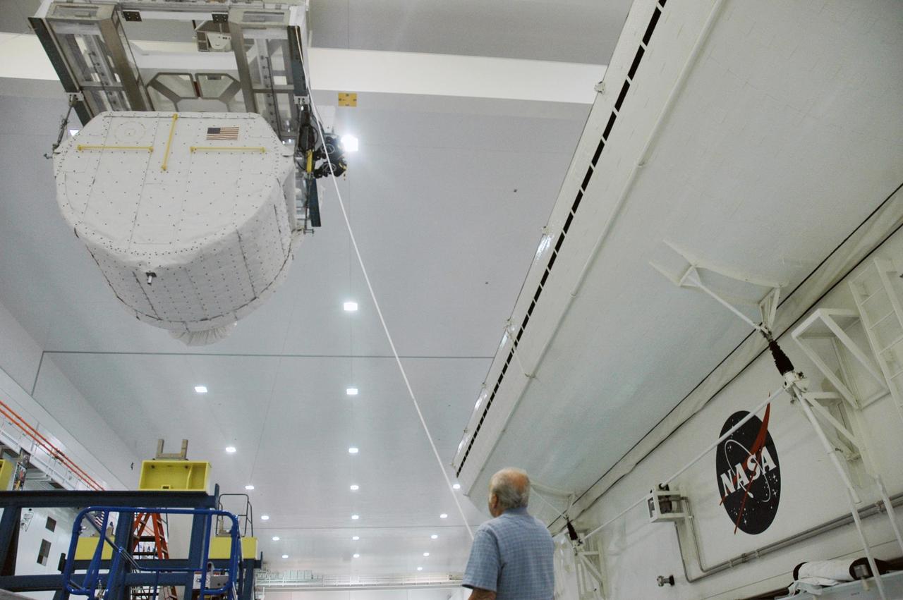 KENNEDY SPACE CENTER, FLA. --   Inside the Space Station Processing Facility, an overhead crane carries the SPACEHAB Module towards the Payload Canister. The SPACEHAB Module will carry racks of experiments, flight hardware, spacewalk equipment and supplies to support mission STS-116 to the International Space Station.  STS-116 will be mission number 20 to the station and construction flight 12A.1. Along with SPACEHAB, the mission payload on Space Shuttle Discovery includes the P5 integrated truss structure and other key components. The launch window opens Dec. 7.  Photo credit: NASA/Troy Cryder