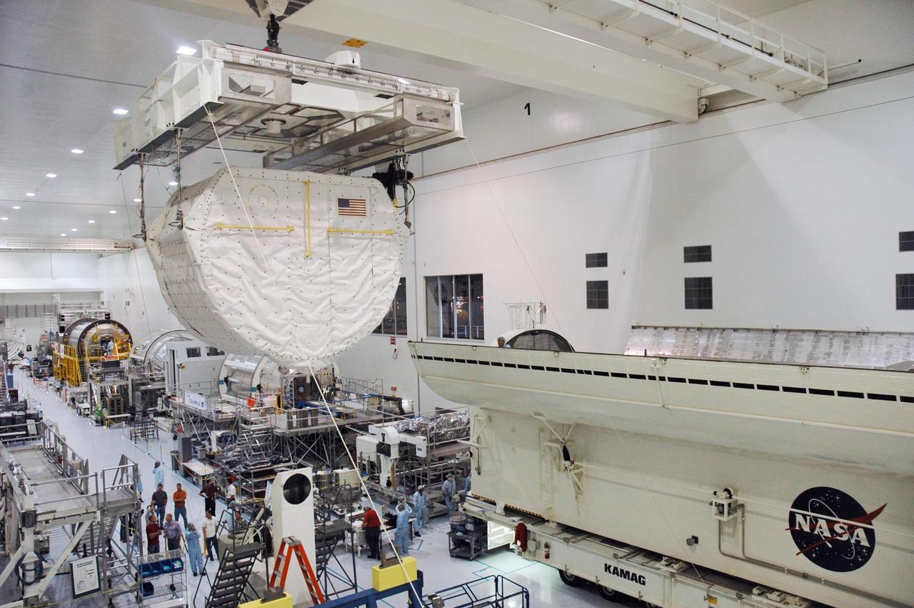 KENNEDY SPACE CENTER, FLA. --    Inside the Space Station Processing Facility, an overhead crane carries the SPACEHAB Module towards the Payload Canister. The SPACEHAB Module will carry racks of experiments, flight hardware, spacewalk equipment and supplies to support mission STS-116 to the International Space Station.  STS-116 will be mission number 20 to the station and construction flight 12A.1. Along with SPACEHAB, the mission payload on Space Shuttle Discovery includes the P5 integrated truss structure and other key components. The launch window opens Dec. 7.  Photo credit: NASA/Troy Cryder