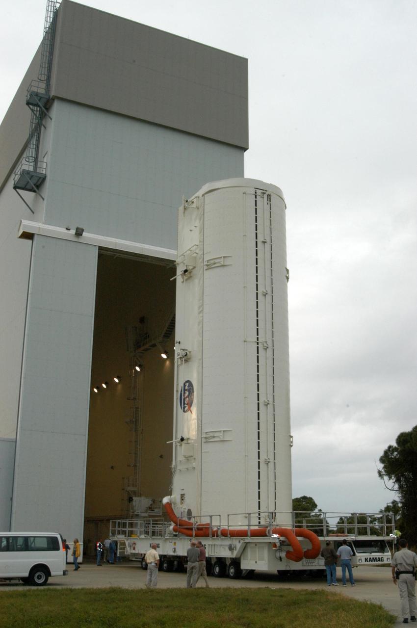 KENNEDY SPACE CENTER, FLA. --  Installed on a transporter, the payload canister moves out of the Vertical Processing Facility.  Inside the canister are the SPACEHAB module and the port 5 truss segment for mission STS-116.  They will be moved into the payload changeout room at the pad and transferred into Space Shuttle Discovery's payload bay once the vehicle has rolled out to the pad. The payload canister is 65 feet long, 18 feet wide and 18 feet, 7 inches high. It has the capability to carry vertically or horizontally processed payloads up to 15 feet in diameter and 60 feet long, matching the capacity of the orbiter payload bay. It can carry payloads weighing up to 65,000 pounds. Clamshell-shaped doors at the top of the canister operate like the orbiter payload bay doors, with the same allowable clearances. Photo credit: NASA/George Shelton