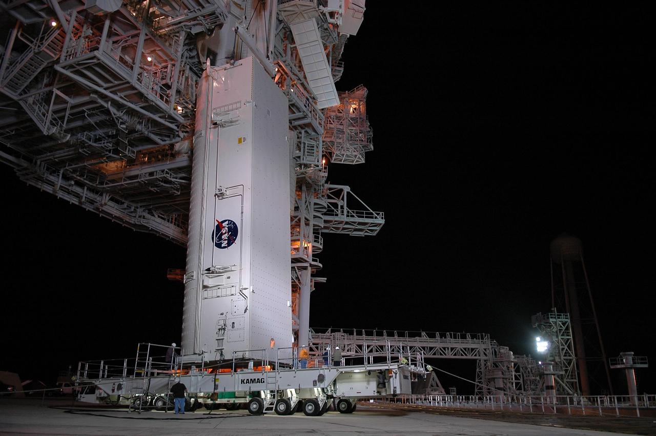 KENNEDY SPACE CENTER, FLA. --  The payload canister is raised off the transporter and will be lifted up to the payload changeout room (PCR) on the rotating service structure (RSS) on Launch Pad 39B.  Inside the canister are the SPACEHAB module and the port 5 truss segment for mission STS-116.  Once inside the PCR, they will be transferred into Space Shuttle Discovery's payload bay once the vehicle has rolled out to the pad.  The PCR is the enclosed, environmentally controlled portion of the RSS that supports cargo delivery to the pad and subsequent vertical installation into the orbiter payload bay. Seals around the mating surface of the PCR fit against the orbiter and allow the opening of the payload bay or canister doors and removal of the cargo without exposure to outside air and contaminants. A clean-air purge in the PCR maintains environmental control during PCR cargo operations. Cargo is removed from the payload canister and installed vertically in the orbiter by the payload ground handling mechanism (PGHM). Photo credit: NASA/Kim Shiflett