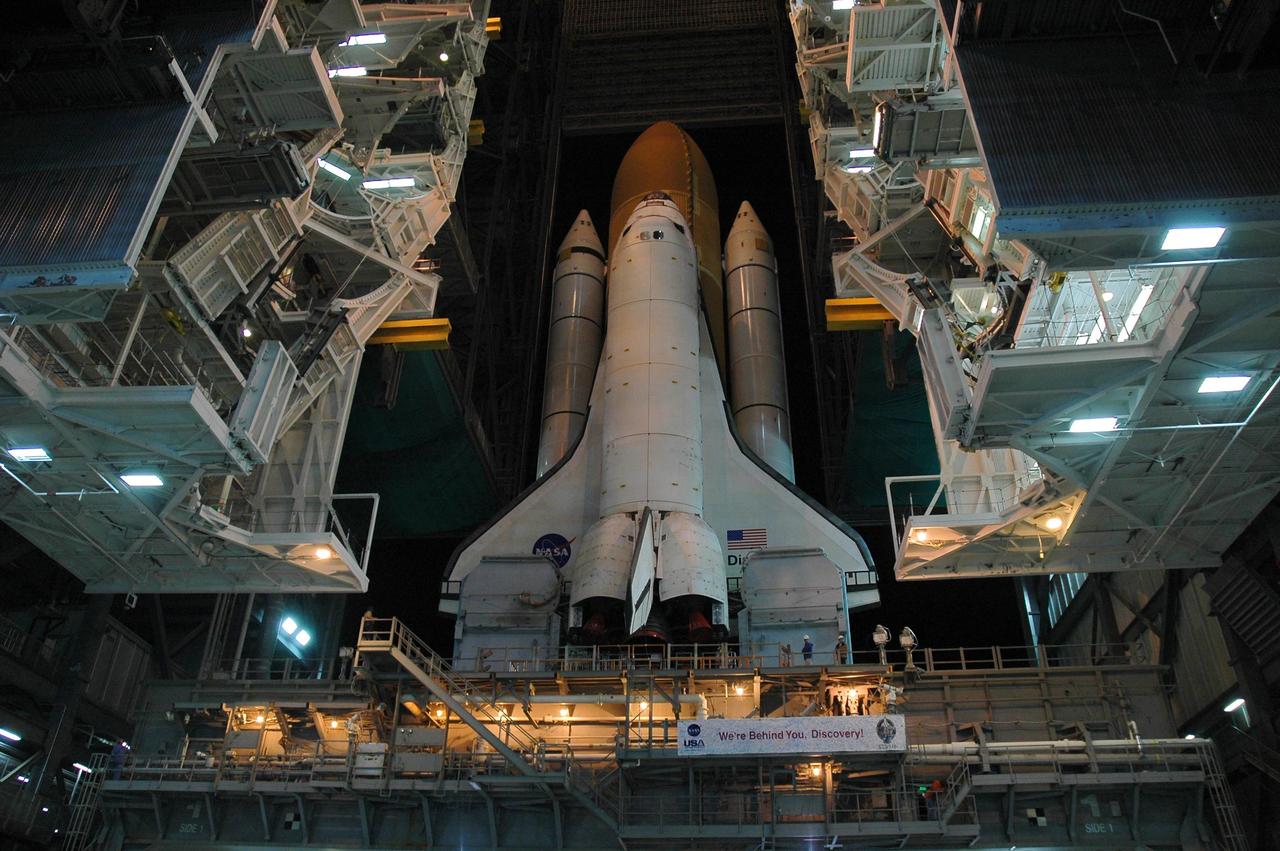 KENNEDY SPACE CENTER, FLA. --  Space Shuttle Discovery begins rolling out of high bay 3 of the Vehicle Assembly Building for the long, slow journey to Launch Pad 39B and launch of mission STS-116. The mission is No. 20 to the International Space Station and construction flight 12A.1. The mission payload is the SPACEHAB module, the P5 integrated truss structure and other key components. The launch window for mission STS-116 opens Dec. 7. Photo credit: NASA/Amanda Diller
