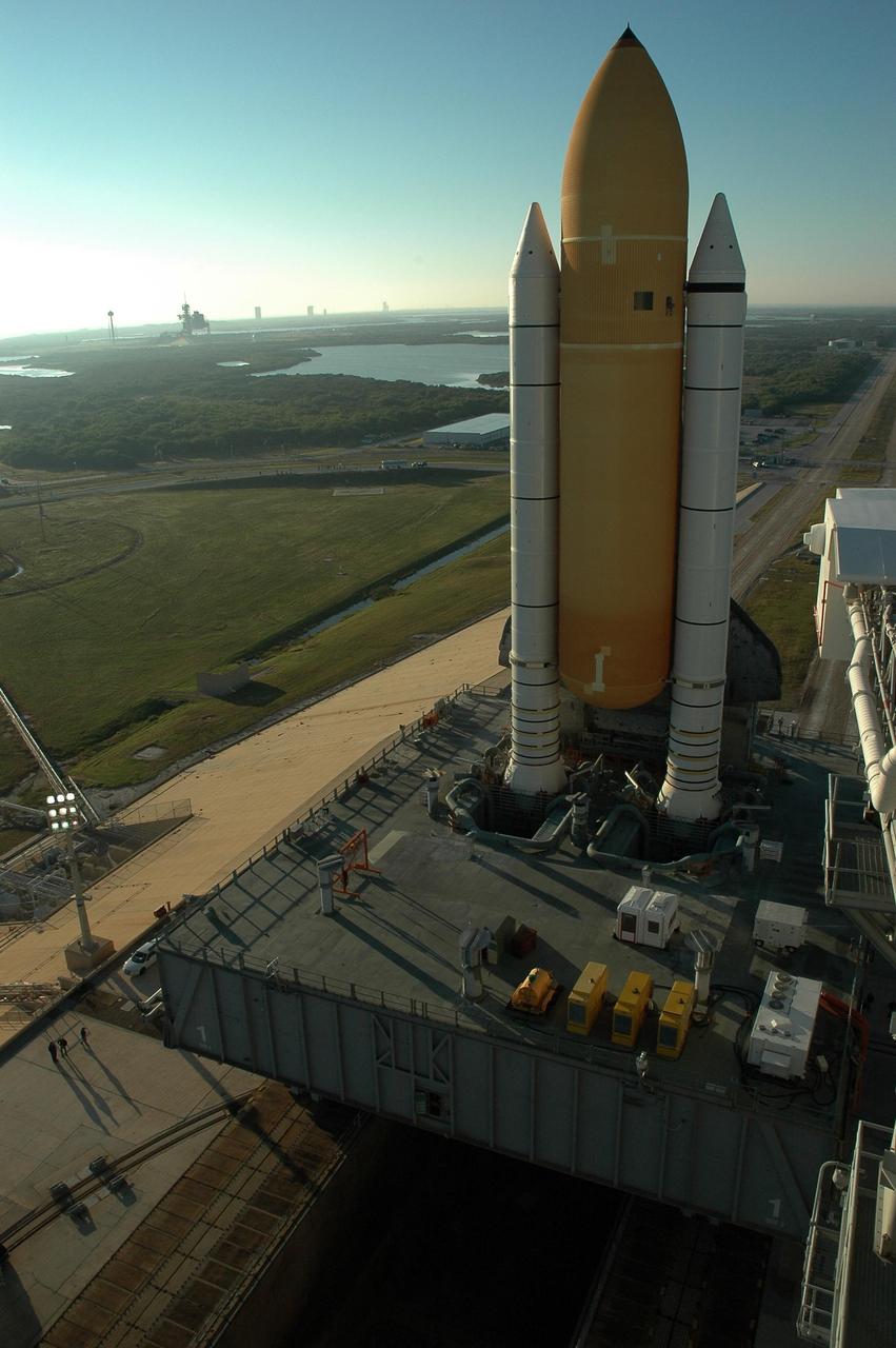 KENNEDY SPACE CENTER, FLA. --  Space Shuttle Discovery, on top of the mobile launcher platform and crawler-transporter, reaches Launch Pad 39B for launch of mission STS-116. On the right edge of the photo can be seen the White Room at the end of the orbiter access arm.  On the horizon at left is Launch Pad 39A.  The rollout from the Vehicle Assembly Building began at 12:29 a.m. The mission is No. 20 to the International Space Station and construction flight 12A.1. The mission payload is the SPACEHAB module, the P5 integrated truss structure and other key components. The launch window for mission STS-116 opens Dec. 7. Photo credit: NASA/Amanda Diller