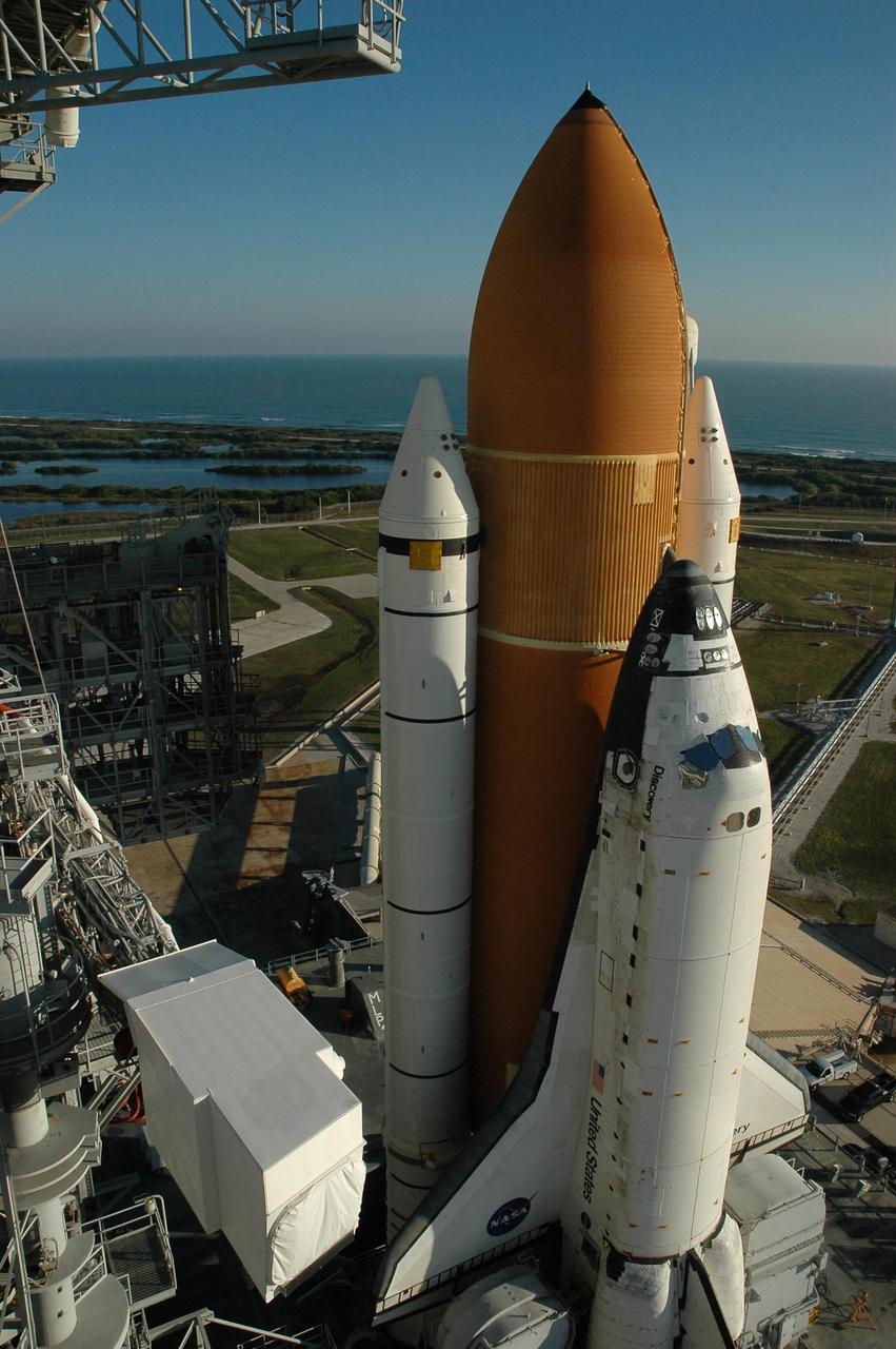 KENNEDY SPACE CENTER, FLA. --  Space Shuttle Discovery reaches Launch Pad 39B for launch of mission STS-116. On the left can be seen the White Room at the end of the orbiter access arm.  On the horizon is the Atlantic Ocean.  The shuttle was harddown on the pad at 9:03 a.m. The rollout from the Vehicle Assembly Building began at 12:29 a.m. The mission is No. 20 to the International Space Station and construction flight 12A.1. The mission payload is the SPACEHAB module, the P5 integrated truss structure and other key components. The launch window for mission STS-116 opens Dec. 7. Photo credit: NASA/Amanda Diller