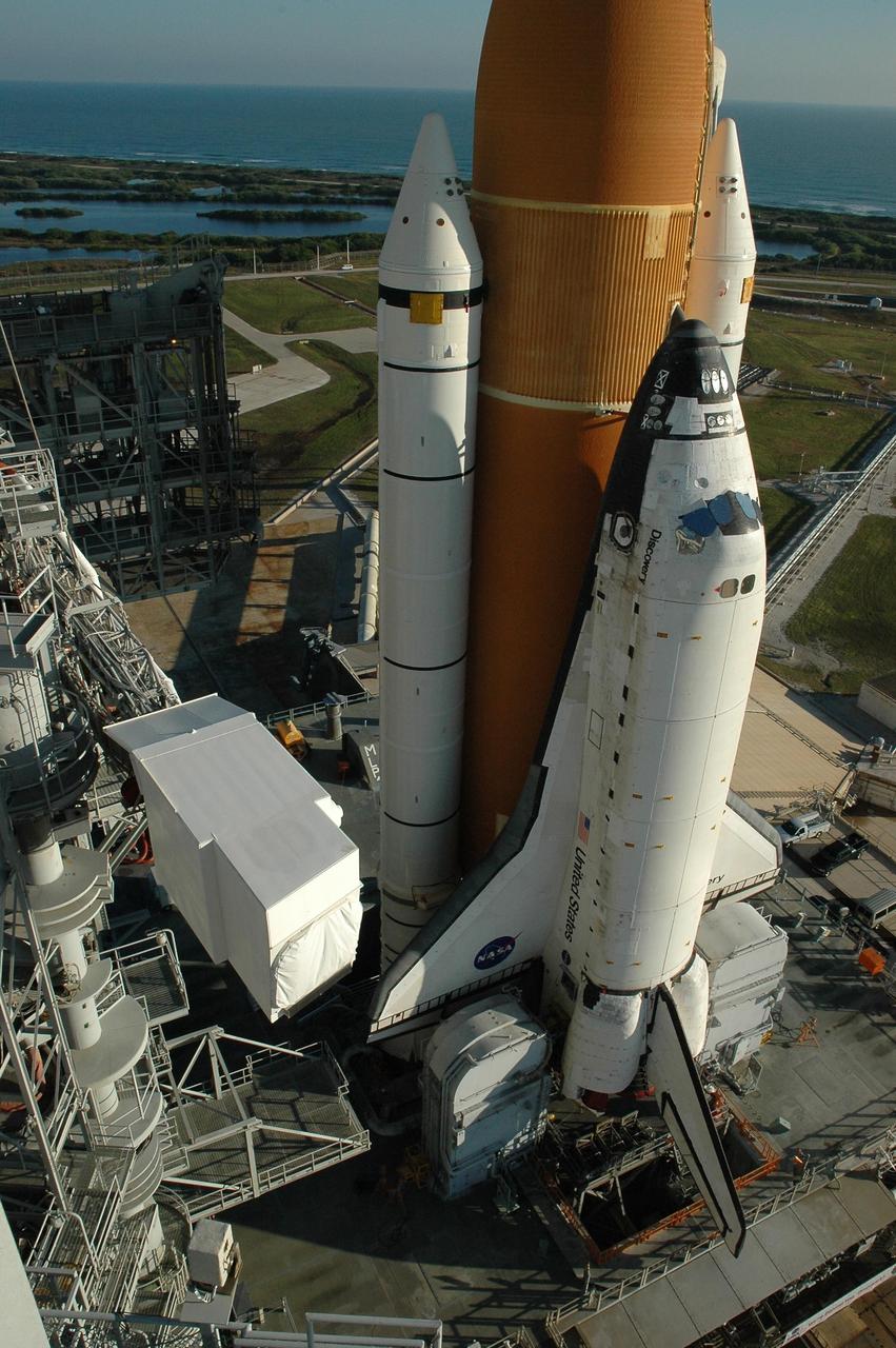 KENNEDY SPACE CENTER, FLA. --  Space Shuttle Discovery reaches Launch Pad 39B for launch of mission STS-116. On the left can be seen the White Room at the end of the orbiter access arm.  On the horizon is the Atlantic Ocean.  The shuttle was harddown on the pad at 9:03 a.m. The rollout from the Vehicle Assembly Building began at 12:29 a.m. The mission is No. 20 to the International Space Station and construction flight 12A.1. The mission payload is the SPACEHAB module, the P5 integrated truss structure and other key components. The launch window for mission STS-116 opens Dec. 7. Photo credit: NASA/Amanda Diller