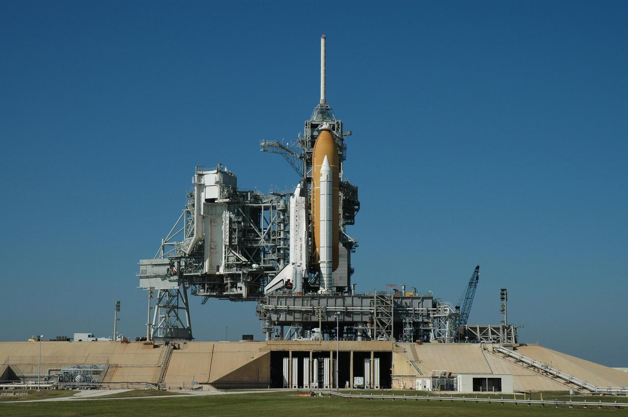 KENNEDY SPACE CENTER, FLA. --  Space Shuttle Discovery sits on Launch Pad 39B for launch of mission STS-116. On the left can be seen the rotating service structure, which will be rolled to enclose the shuttle for servicing and payload transfer. Above the shuttle on the fixed service structure is the 80-foot tall lightning mast. The shuttle was harddown on the pad at 9:03 a.m. The rollout from the Vehicle Assembly Building began at 12:29 a.m. The mission is No. 20 to the International Space Station and construction flight 12A.1. The mission payload is the SPACEHAB module, the P5 integrated truss structure and other key components. The launch window for mission STS-116 opens Dec. 7. Photo credit: NASA/Jim Grossmann